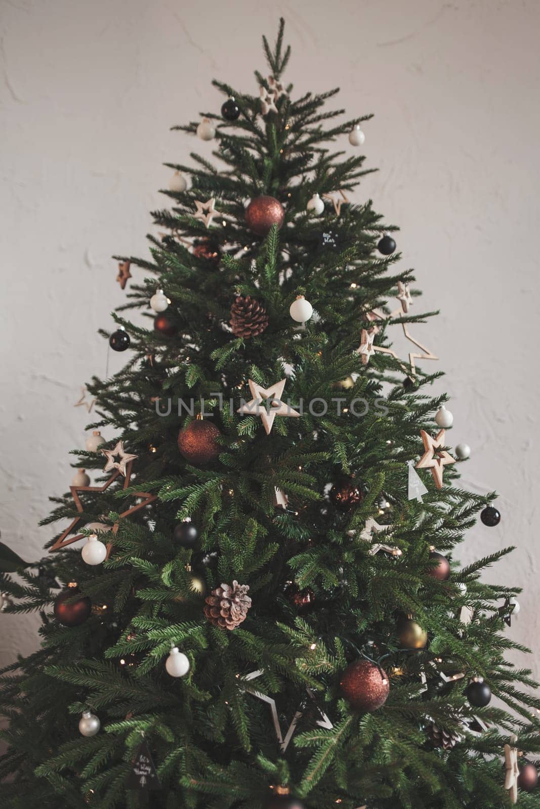 green christmas tree with decorations in the room