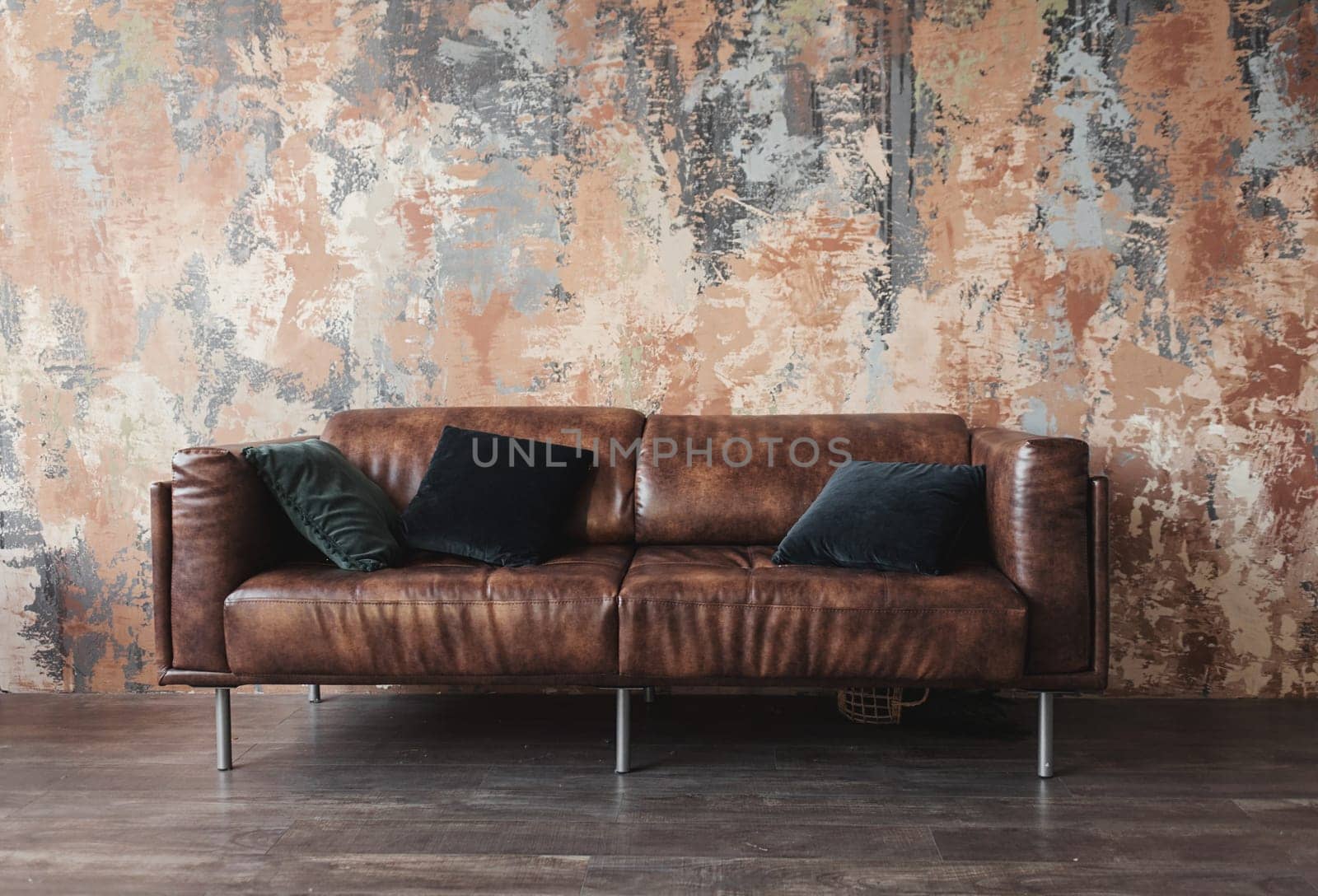 leather sofa with pillows in the loft interior