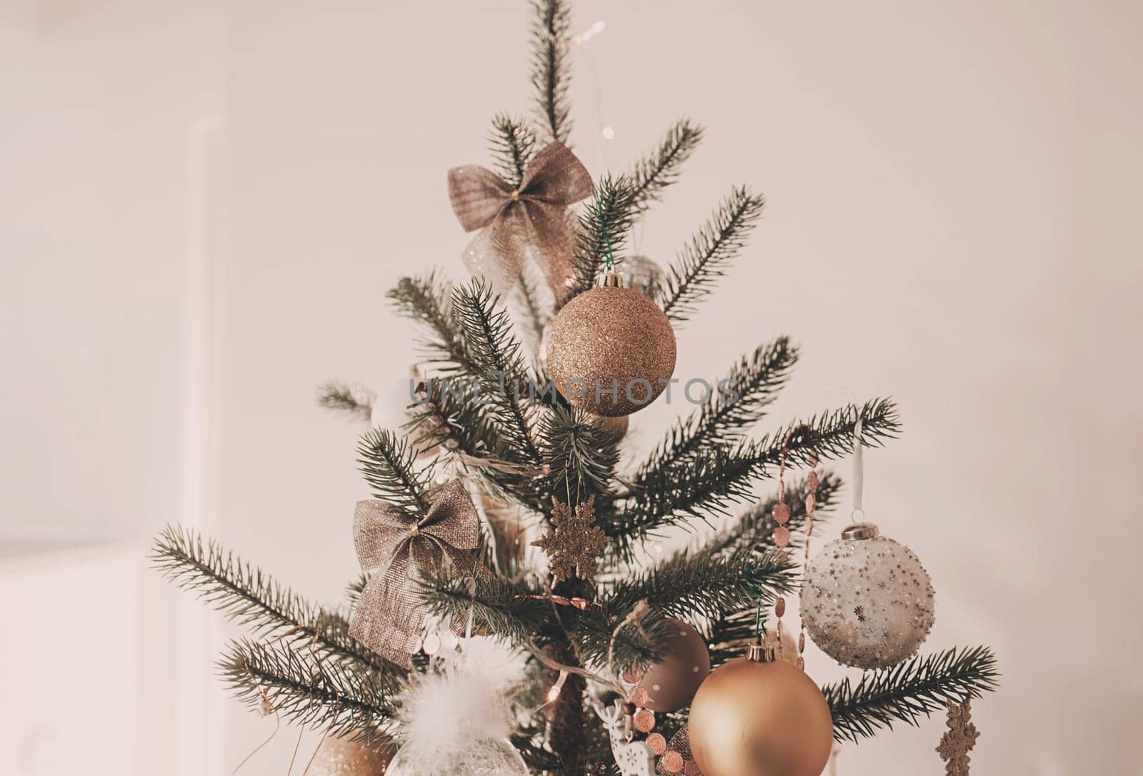 Beautiful green christmas tree decorated with balls and garlands. Close-up photo