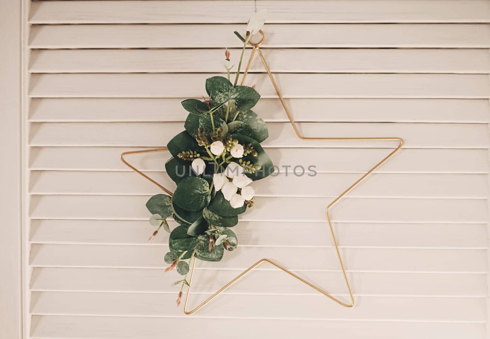 Christmas star hanging on a wooden wall