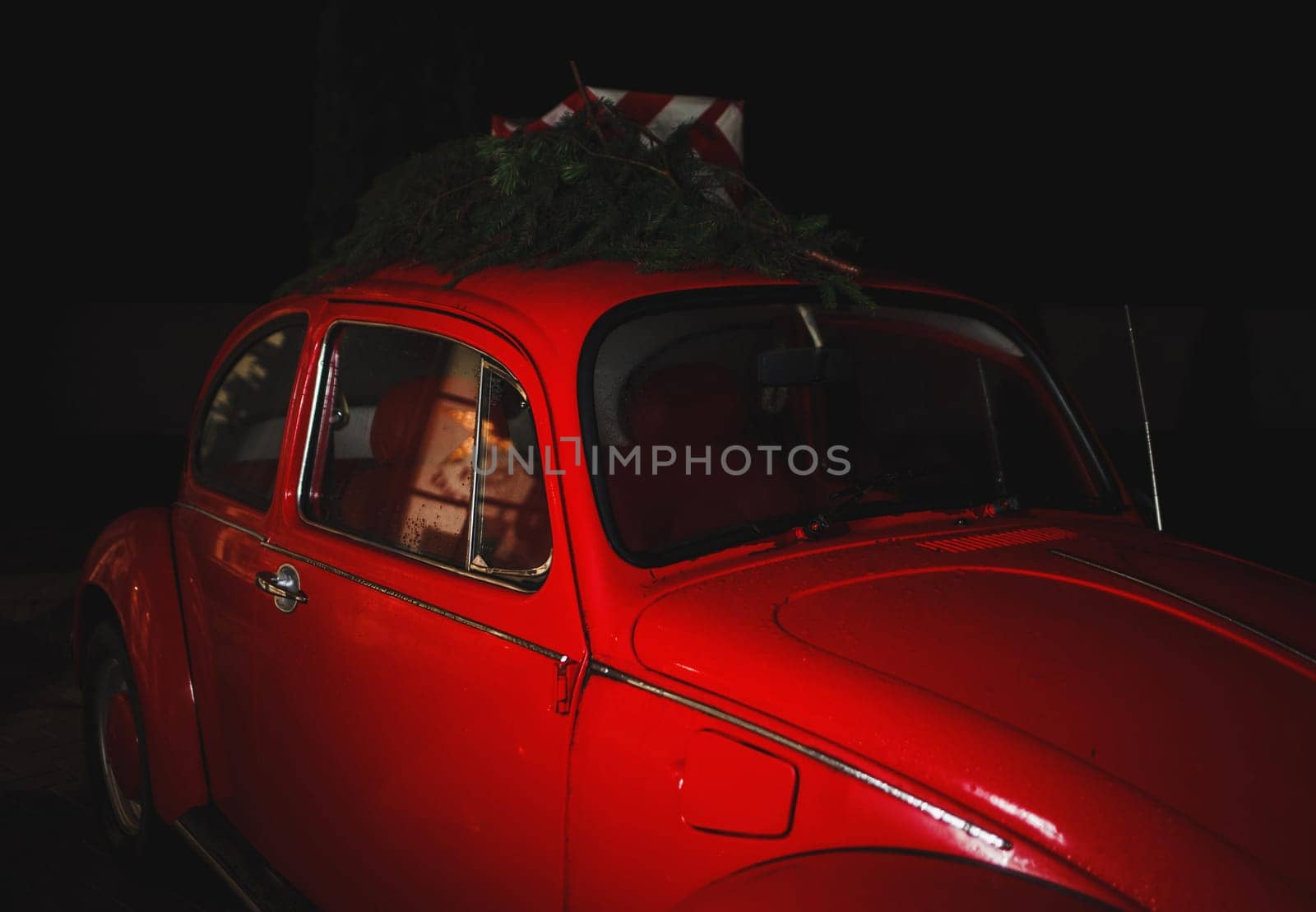 Christmas concept - red retro car with gifts