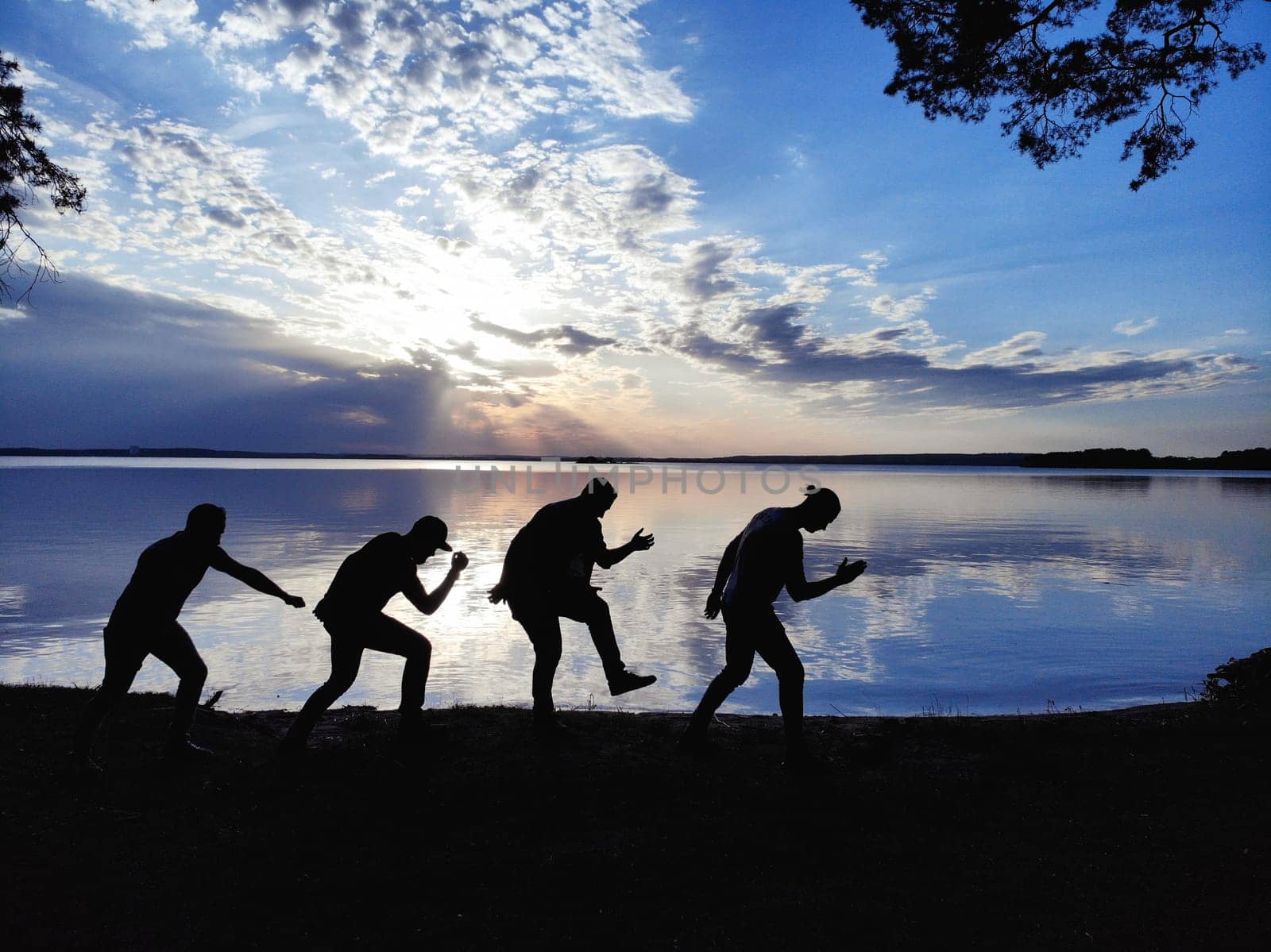 funny silhouettes of a group of people at sunset