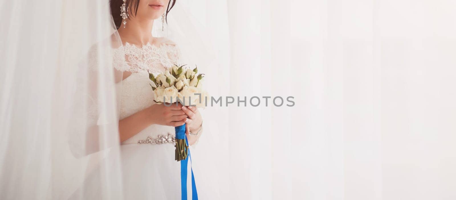 Brides wedding bouquet roses in women's hands. copy space