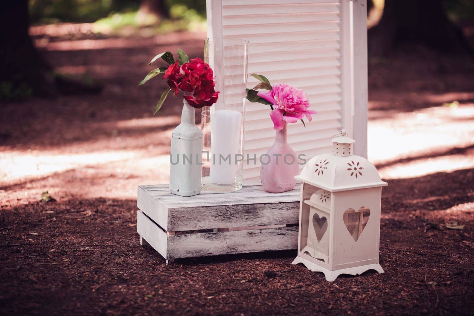 Shabby old home interior decor. Flowers in a vase near the wedding arch. Yard decorations. Valentine's day