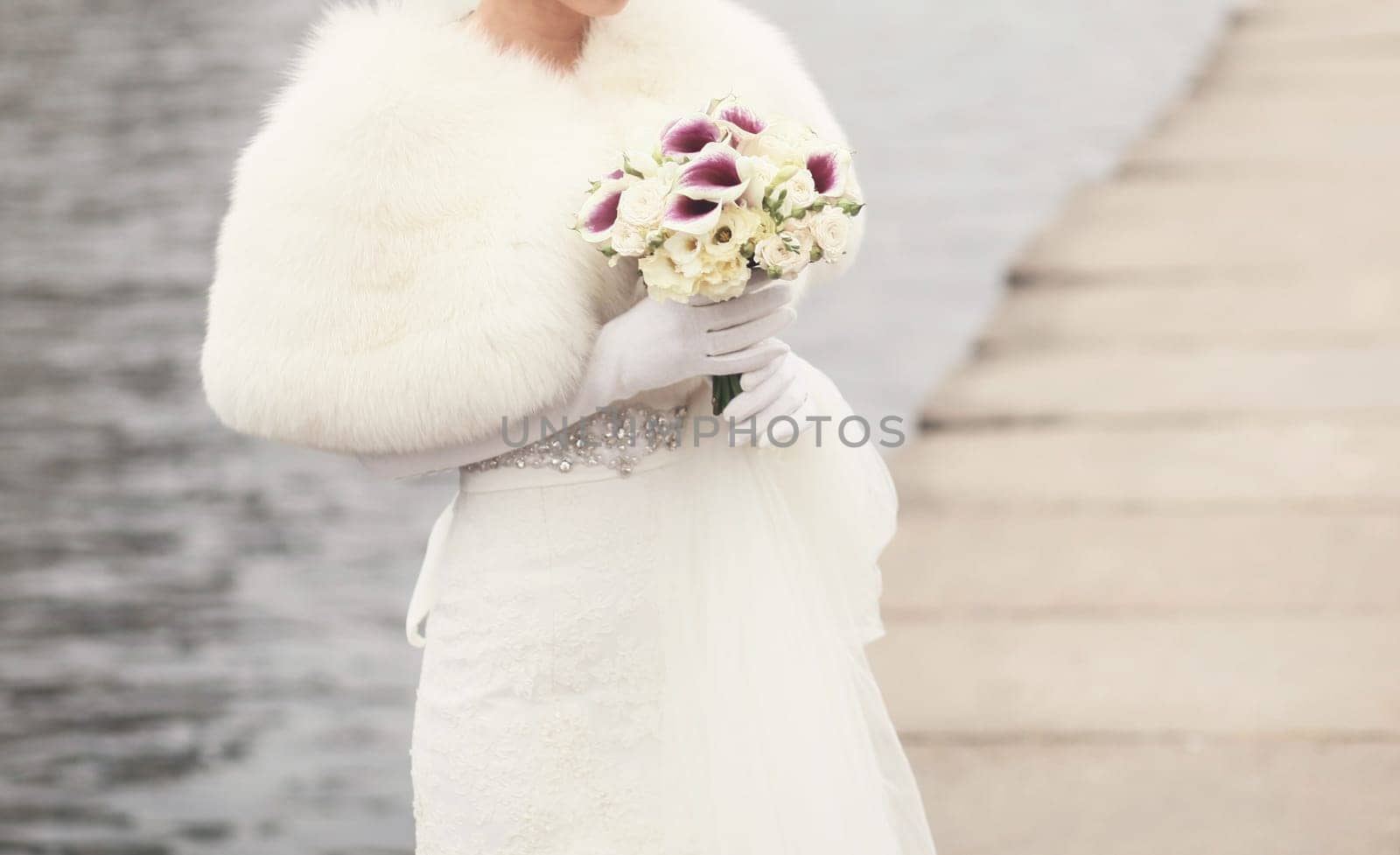 Beautiful wedding bouquet in the hands of the bride outdoors