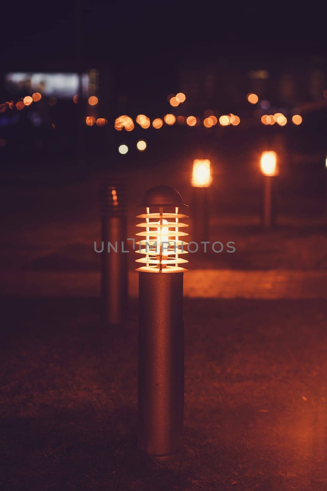 small city lantern glows on the lawn