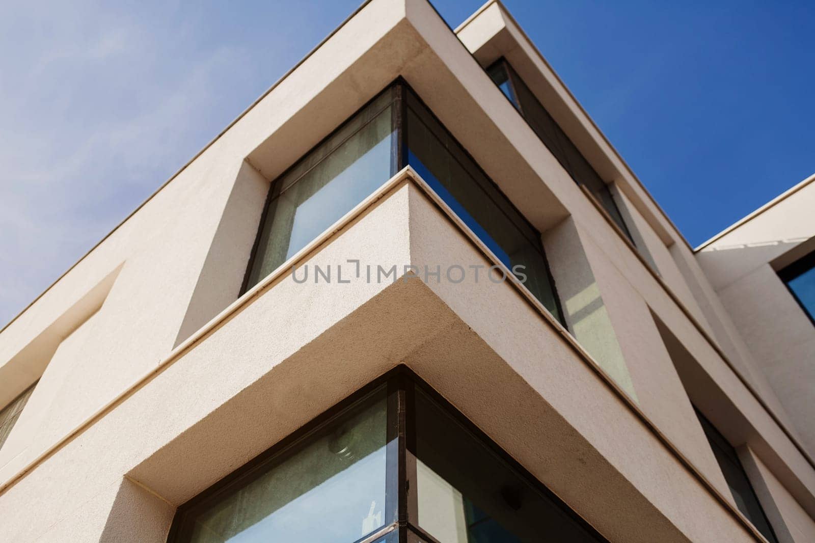 Part of Modern residential apartment with flat building exterior. Detail of New luxury house and home complex. Blue sky