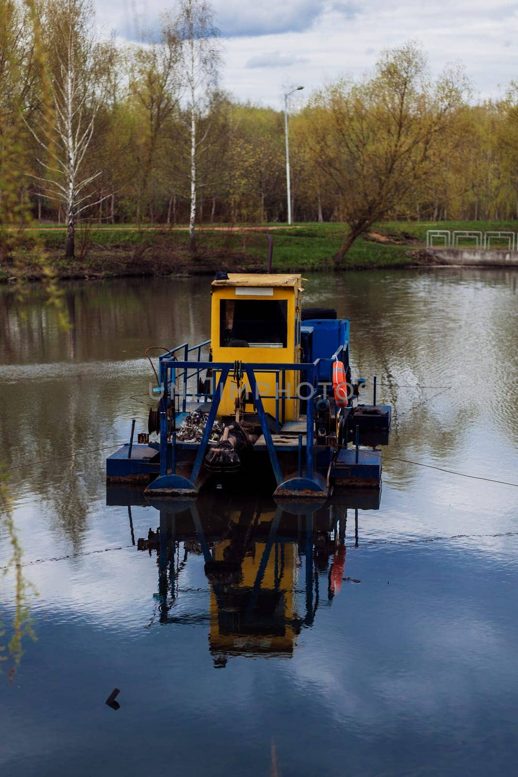 River cleaning boat collects garbage on water by Ladouski