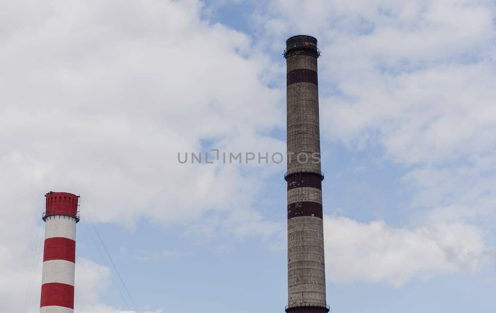 industrial pipes against the sky. global warming. atmospheric pollution