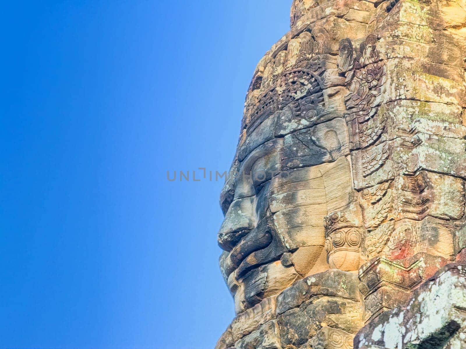 Bodhisattva Avalokiteshvara face on Bayon temple in Angkor, Cambodia by Elenaphotos21