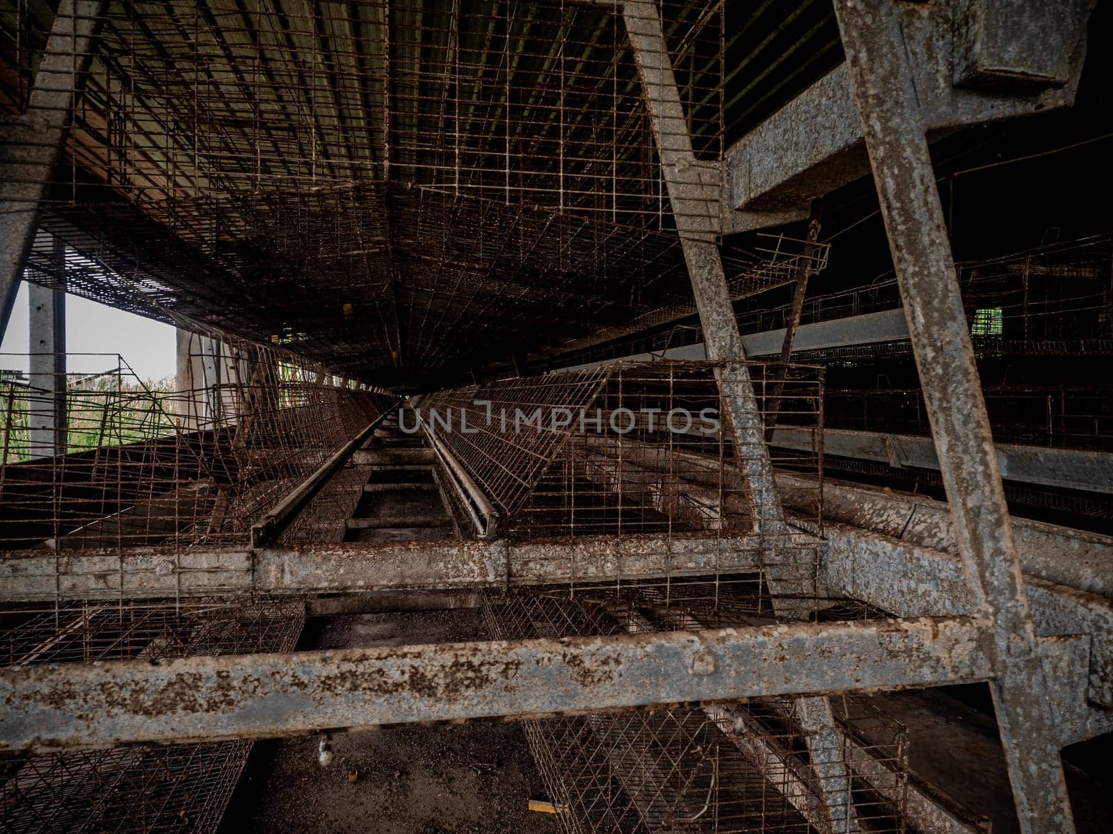 The empty laying cages of poultry houses, old, decayed, abandoned by Satakorn