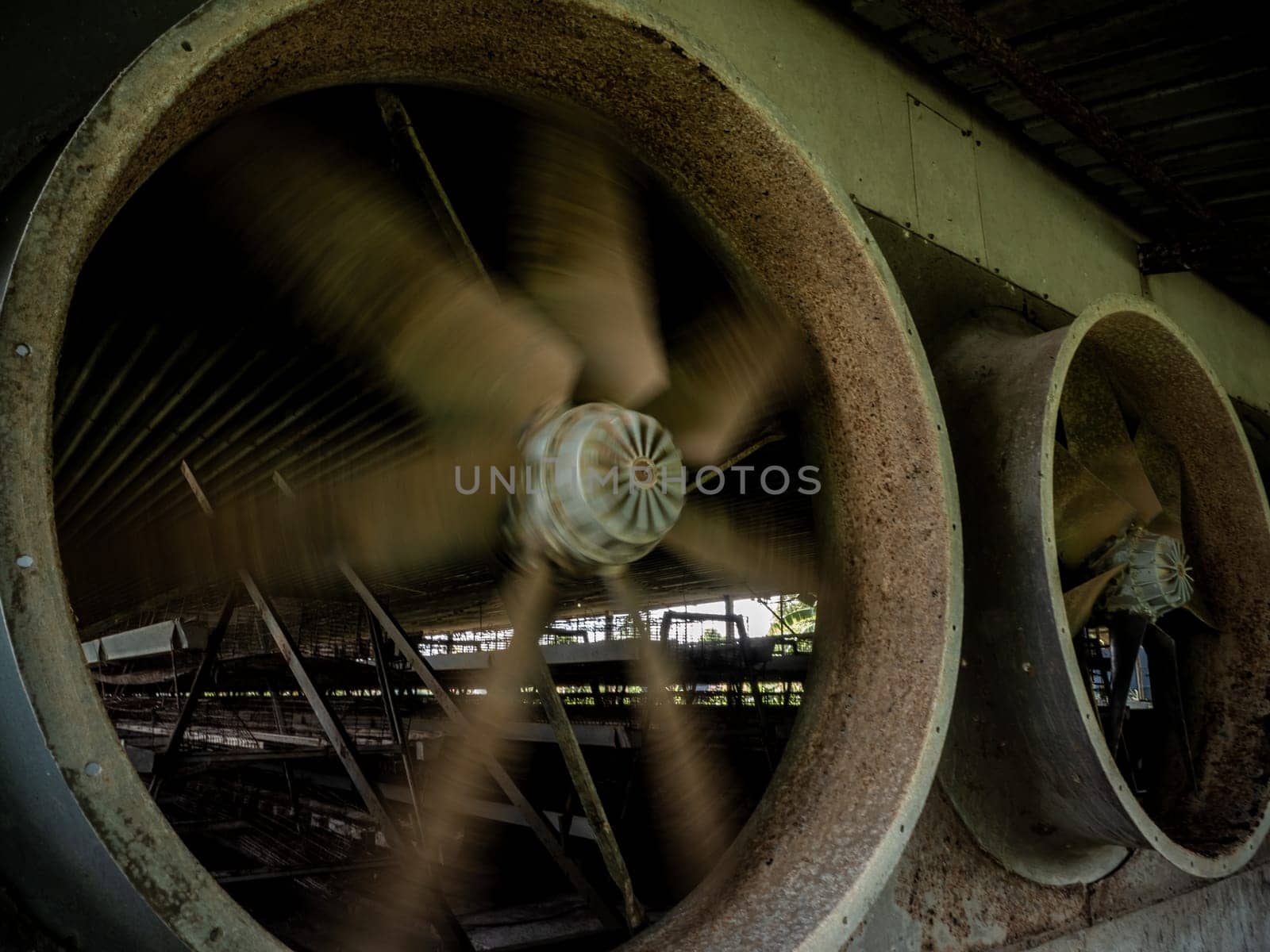 looking inside the livestock house through the space of the exhaust fan blade by Satakorn