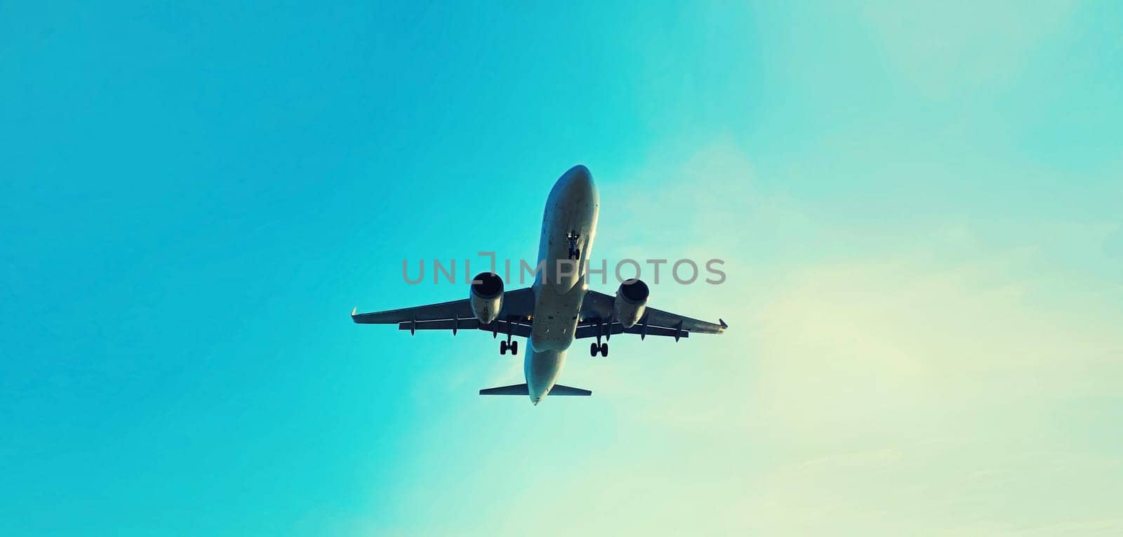 Passenger airplane flying in blue sky background