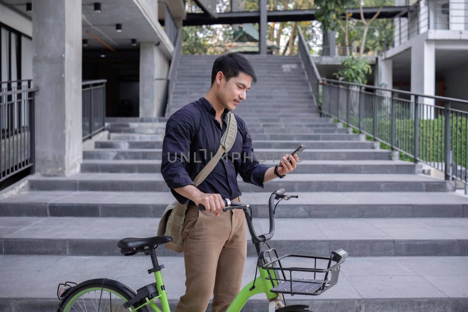 Young Asian businessman Go to work by cycling to reduce air pollution and stay healthy..