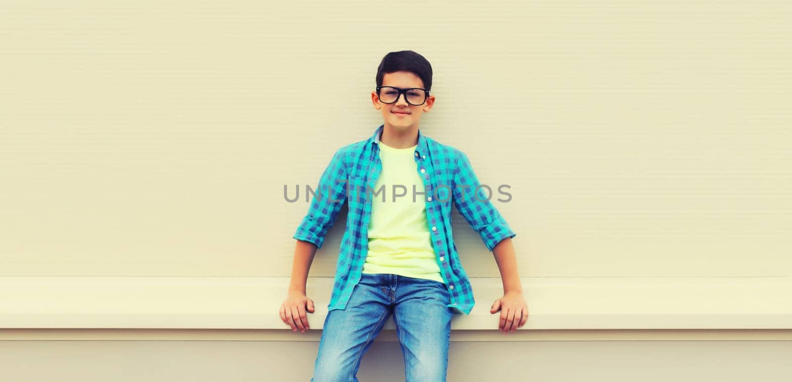 Happy smiling teenager boy in eyeglasses, casual shirt on white background by Rohappy