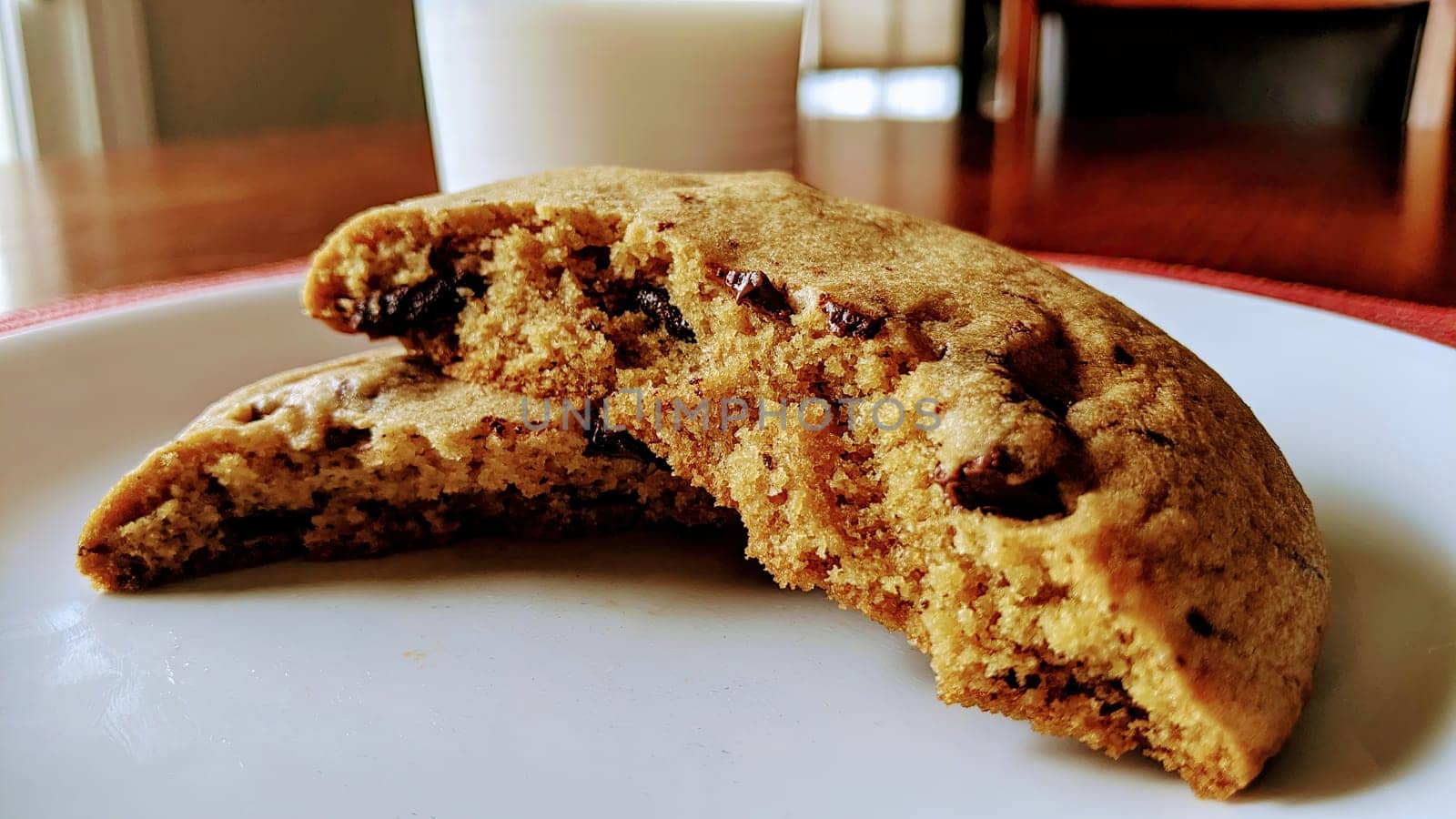 Freshly Baked Chocolate Chip Cookie on White Plate with Glass of Milk in Homely Kitchen, Fort Wayne, Indiana, 2021