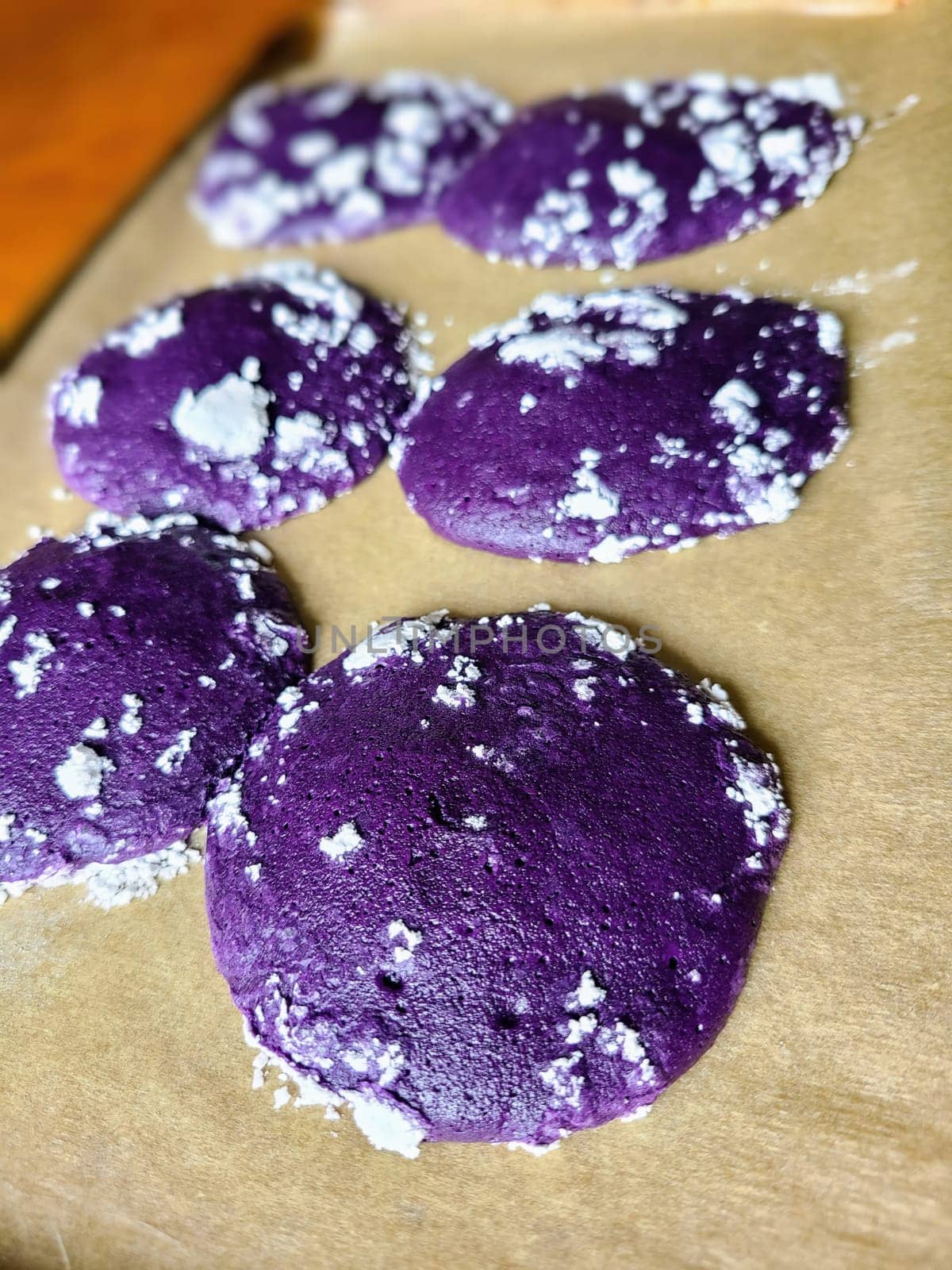 Unique homemade ube purple cookies dusted with sugar in a cozy kitchen setting, Fort Wayne, Indiana, 2023
