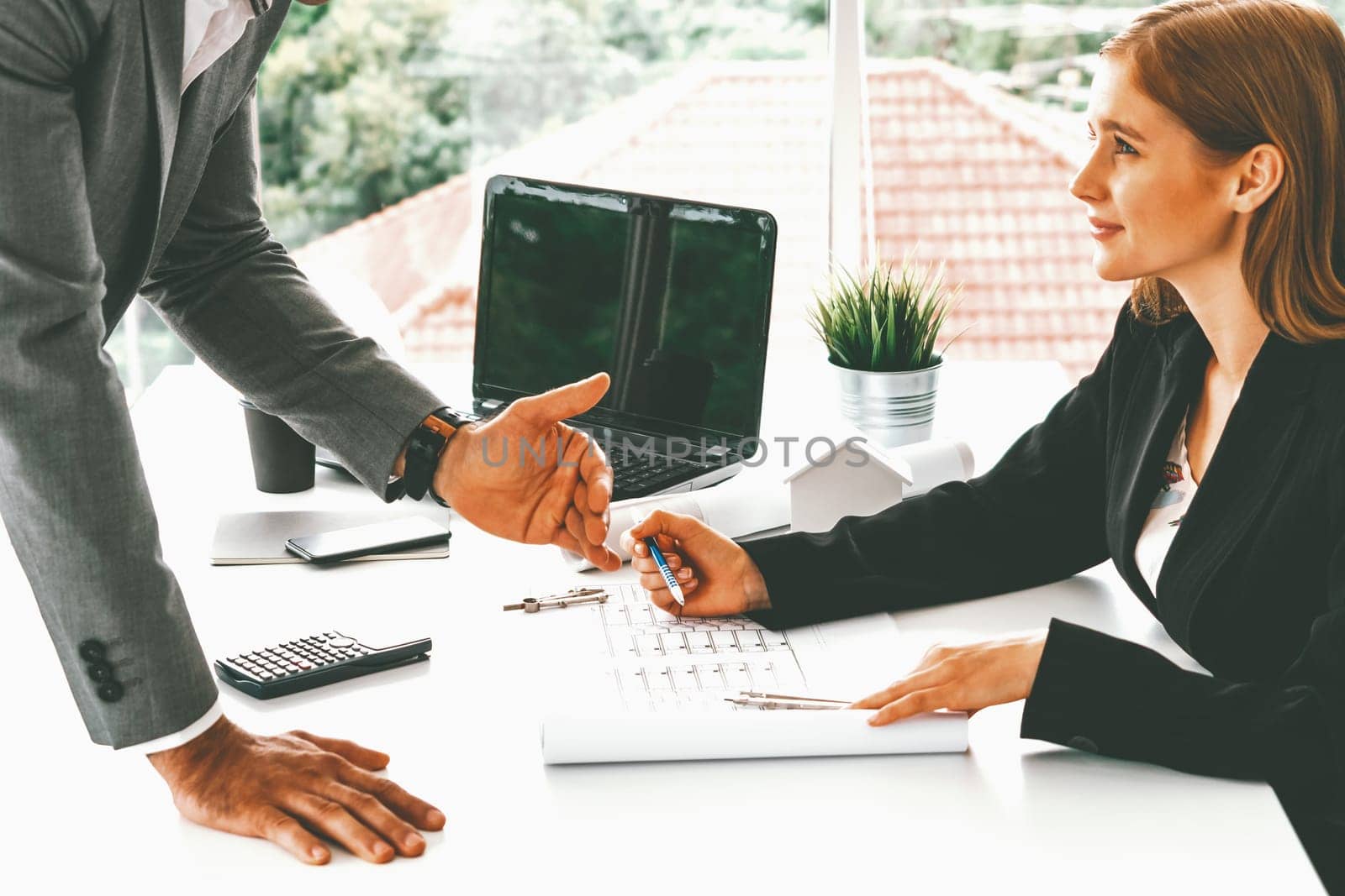 Architect and engineer working with construction drawing project on table in office. Architecture and engineering business concept. uds