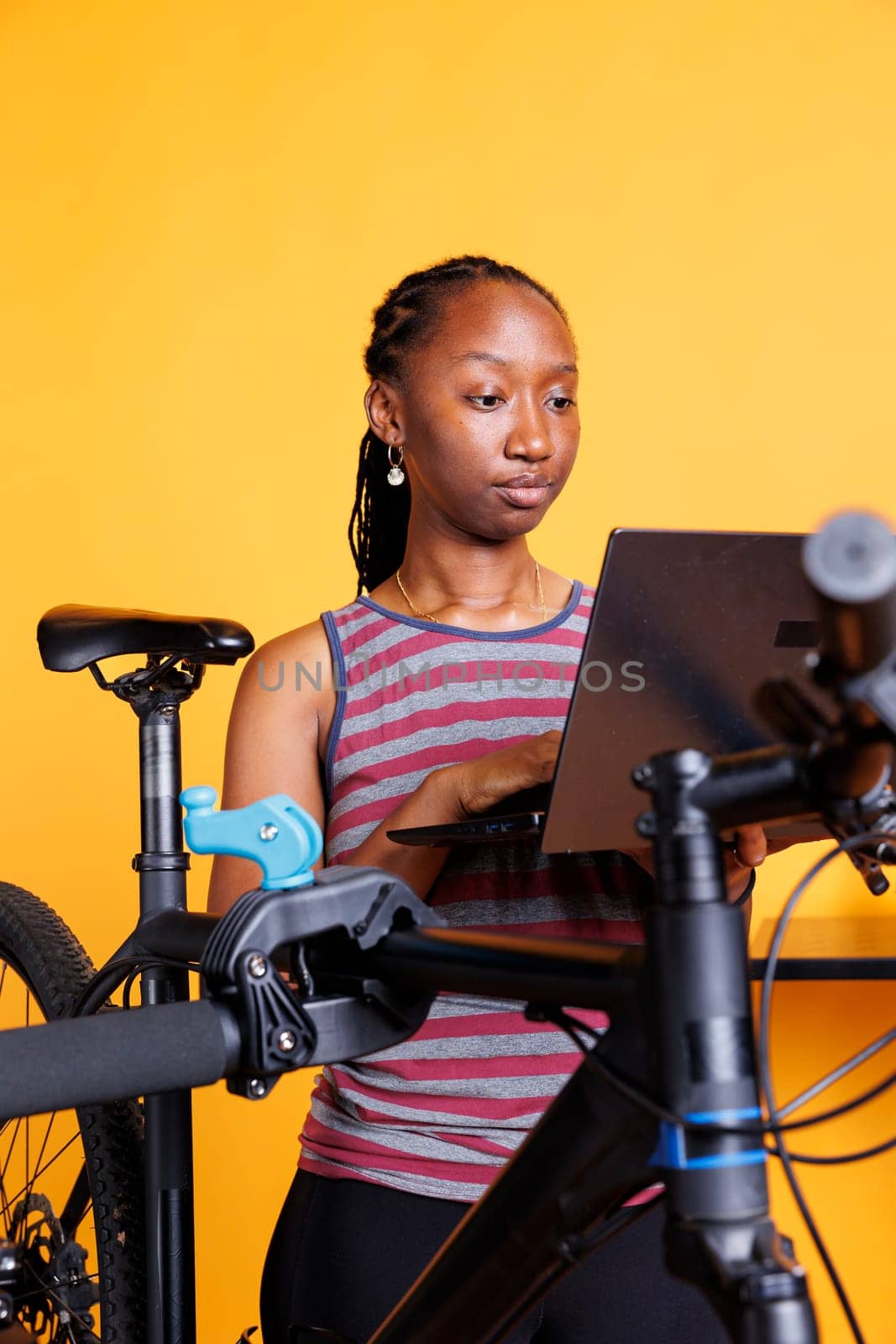 Woman uses technology to repair bicycle by DCStudio