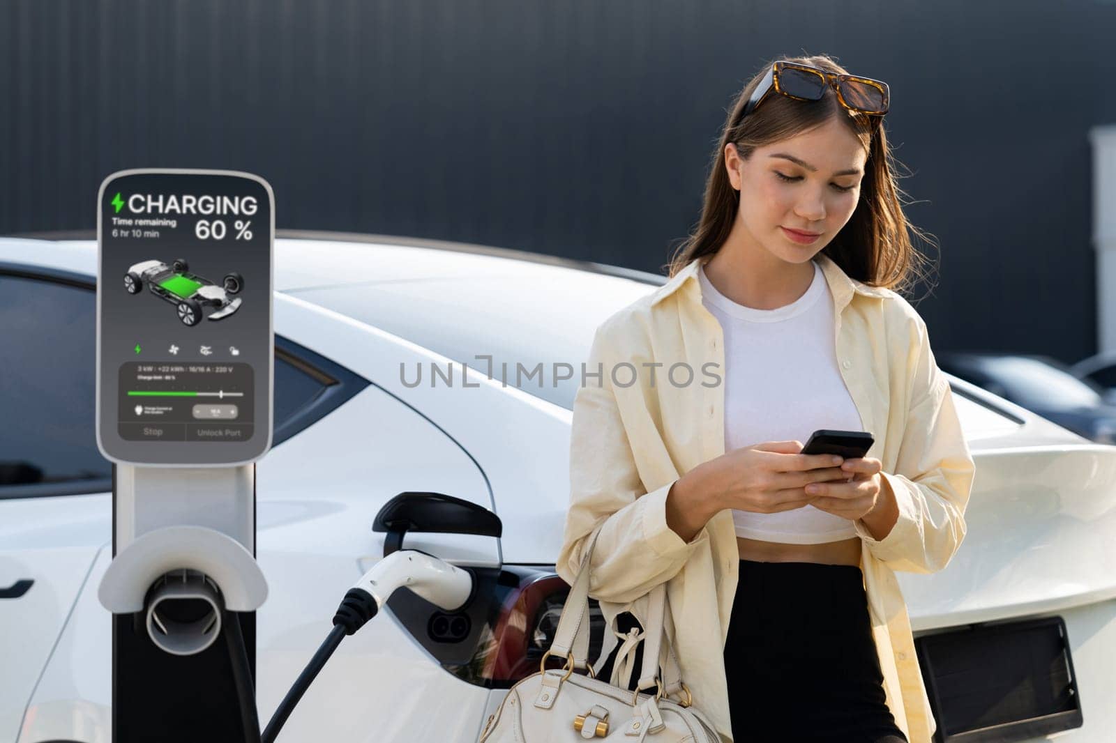 Young woman holding shopping bag recharge EV car. Expedient by biancoblue