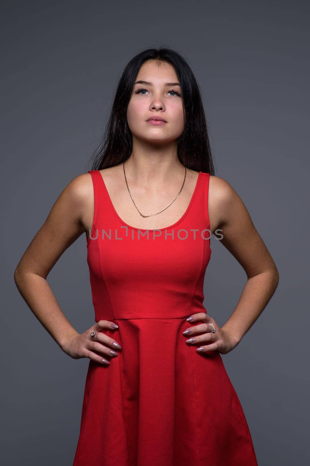 Studio portrait of a young beautiful girl in a red dress 3 by Mixa74