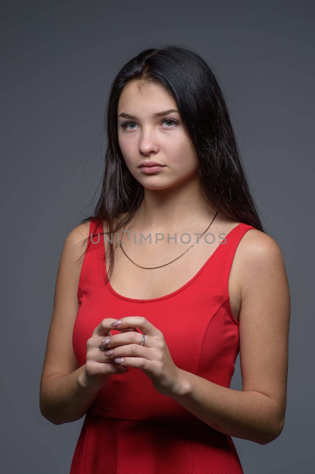 Studio portrait of a young beautiful girl in a red dress 2 by Mixa74