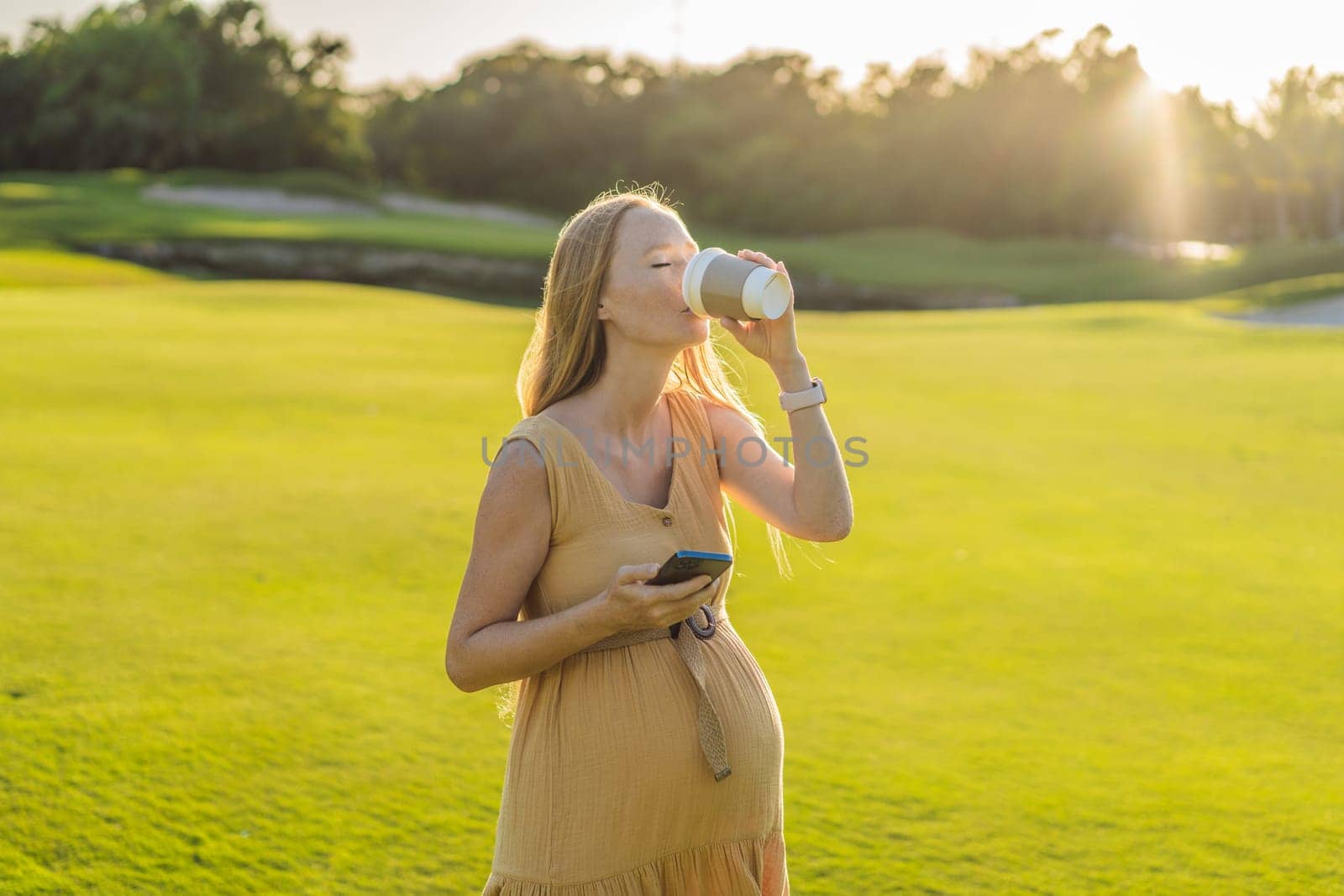 pregnant woman enjoys a cup of coffee outdoors, blending the simple pleasures of nature with the comforting warmth of a beverage during her pregnancy by galitskaya