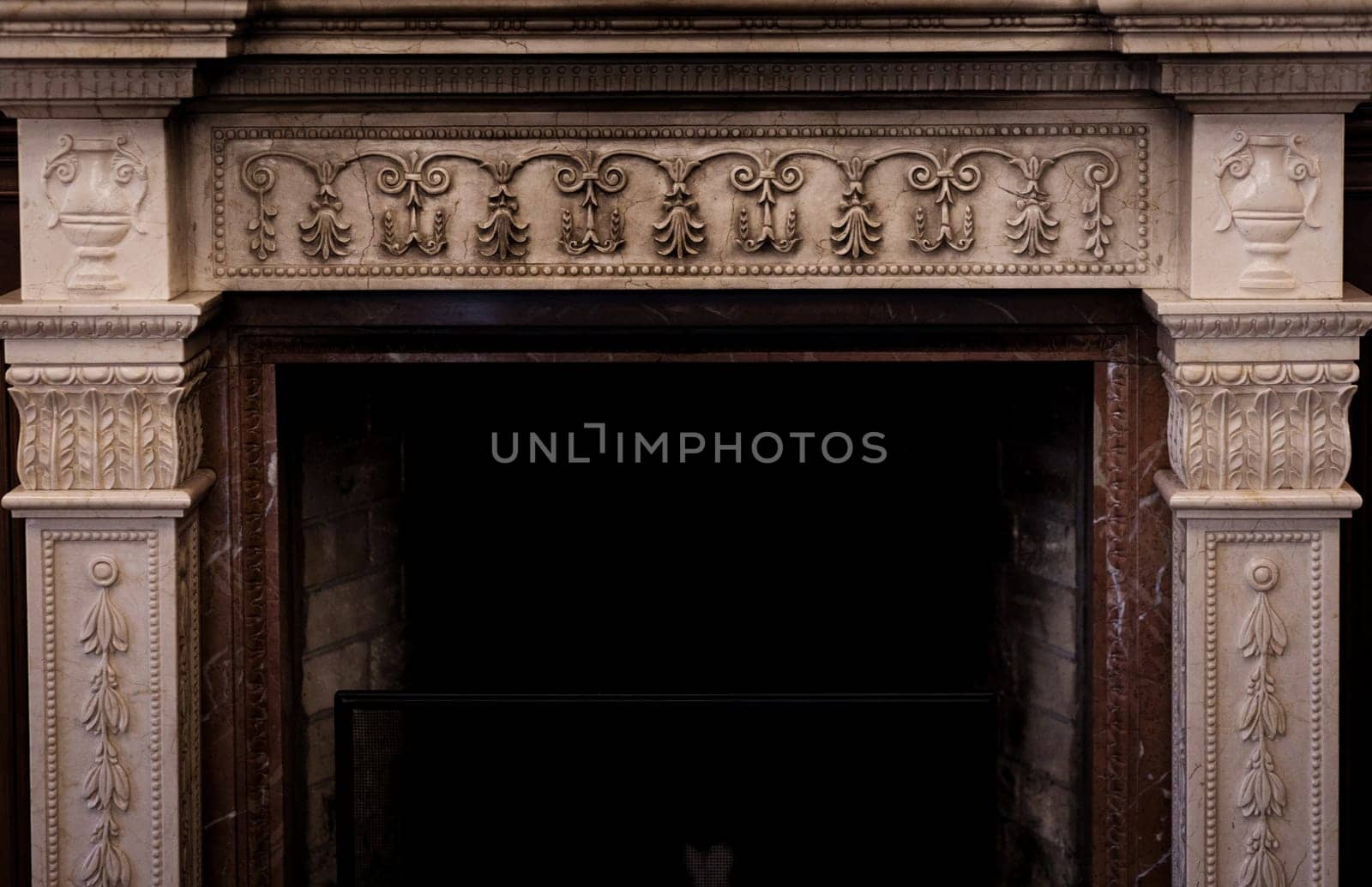 Rich interior with antique fireplace with stucco in vintage room