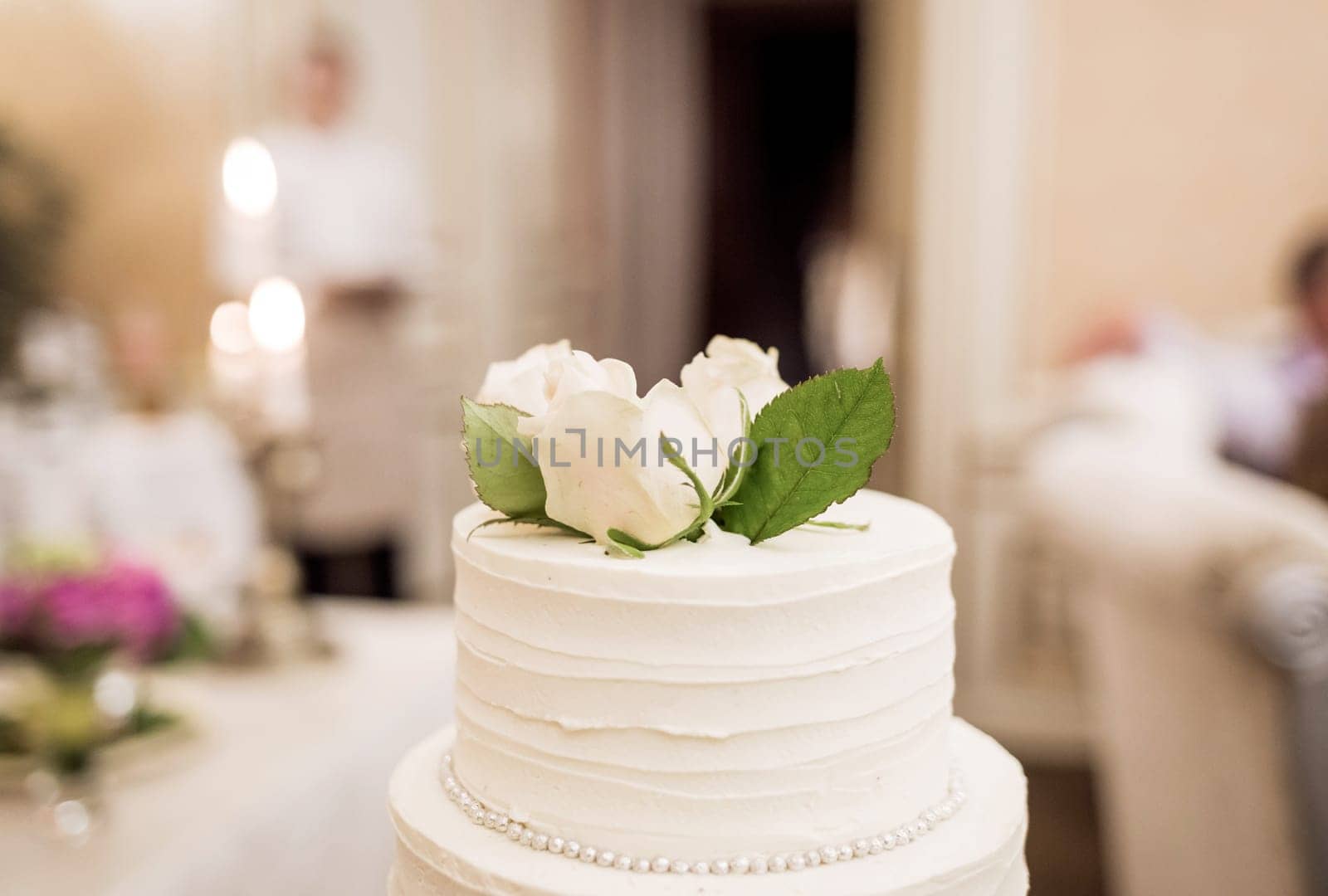 Detail of a food banquet. Tasty cake with roses