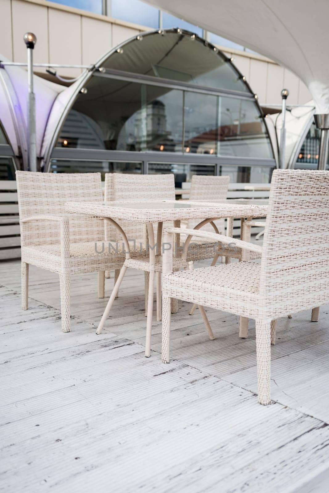cozy outdoor cafe with light chairs.