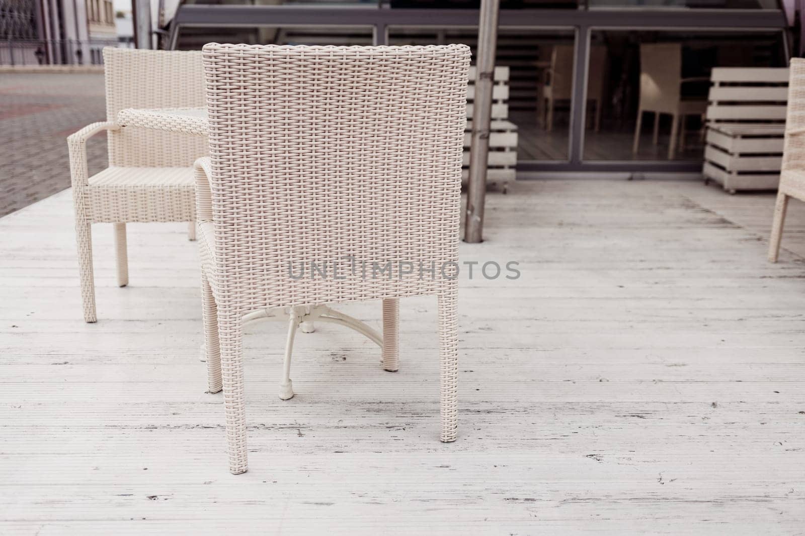 wicker chair in a cozy outdoor cafe. street restaurant