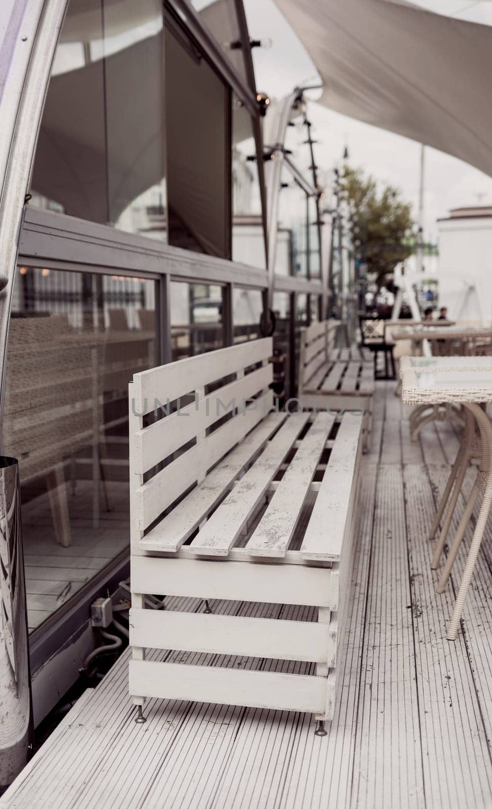 cozy outdoor cafe with wooden furniture. eco chairs