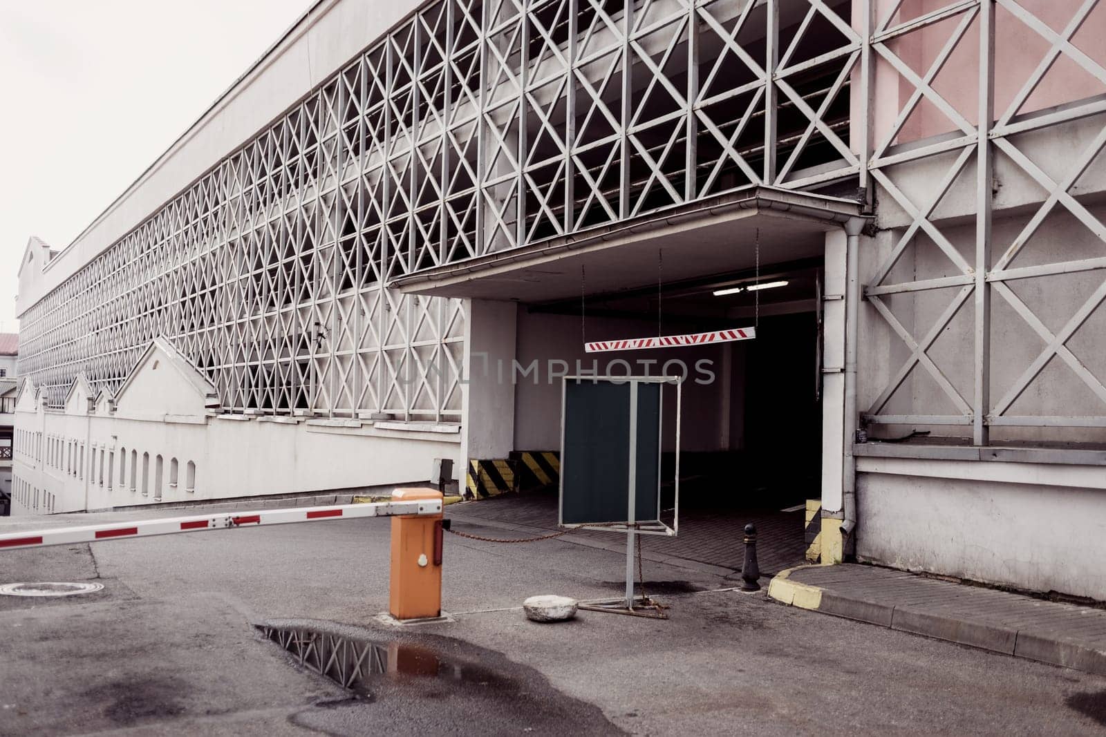 the road near the city parking lot with a barrier