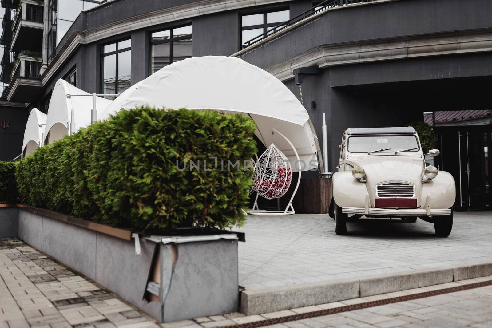 retro car near a street cafe in the center of a European city