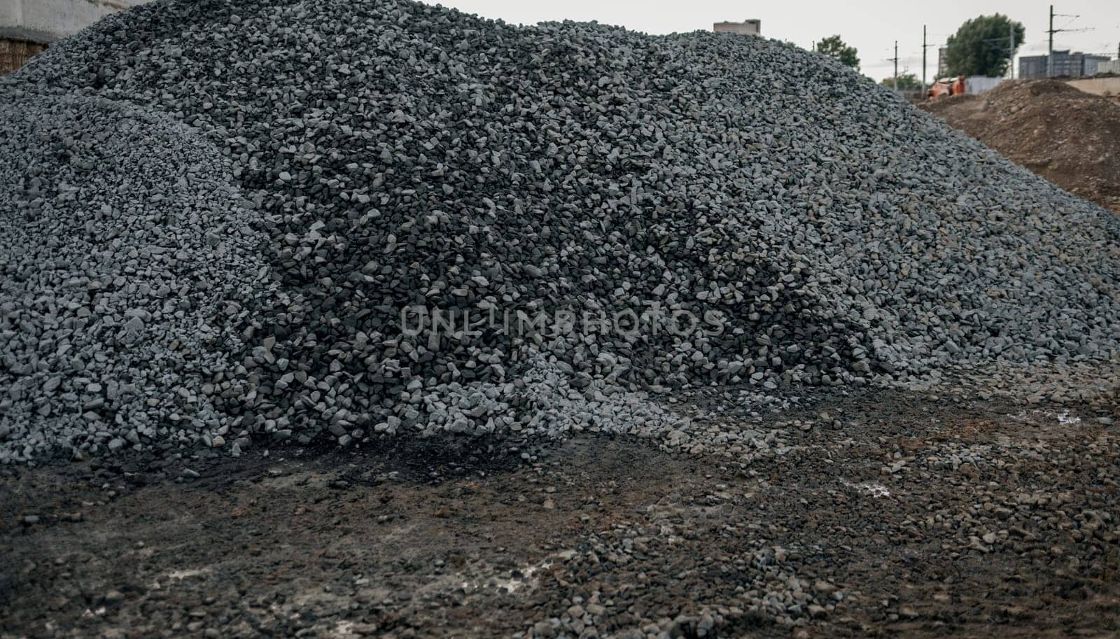 hills of stones for construction industrial. Pile rocks or gravel gray stone textures asphalt mix concrete in road constructions