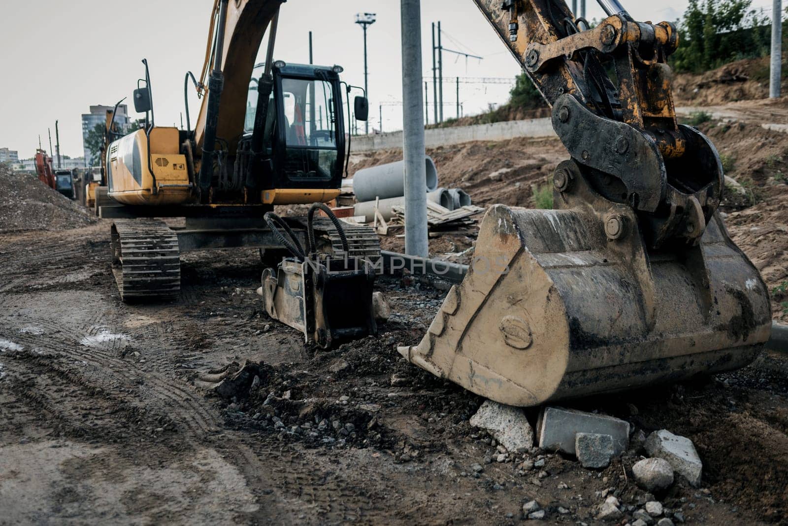 Excavator on construction site. Backhoe on foundation work and road construction. Heavy machinery and construction equipment