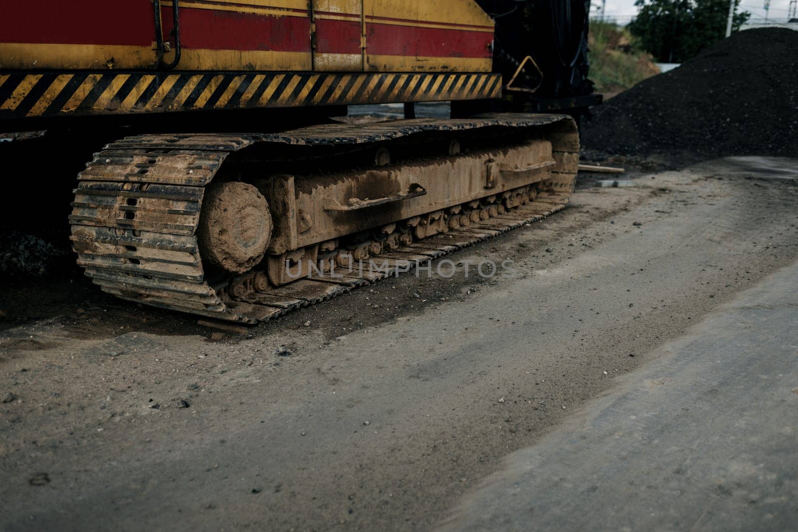 crawler backhoe. A crawler drive chassis of a heavy backhoe machine on a construction site. 