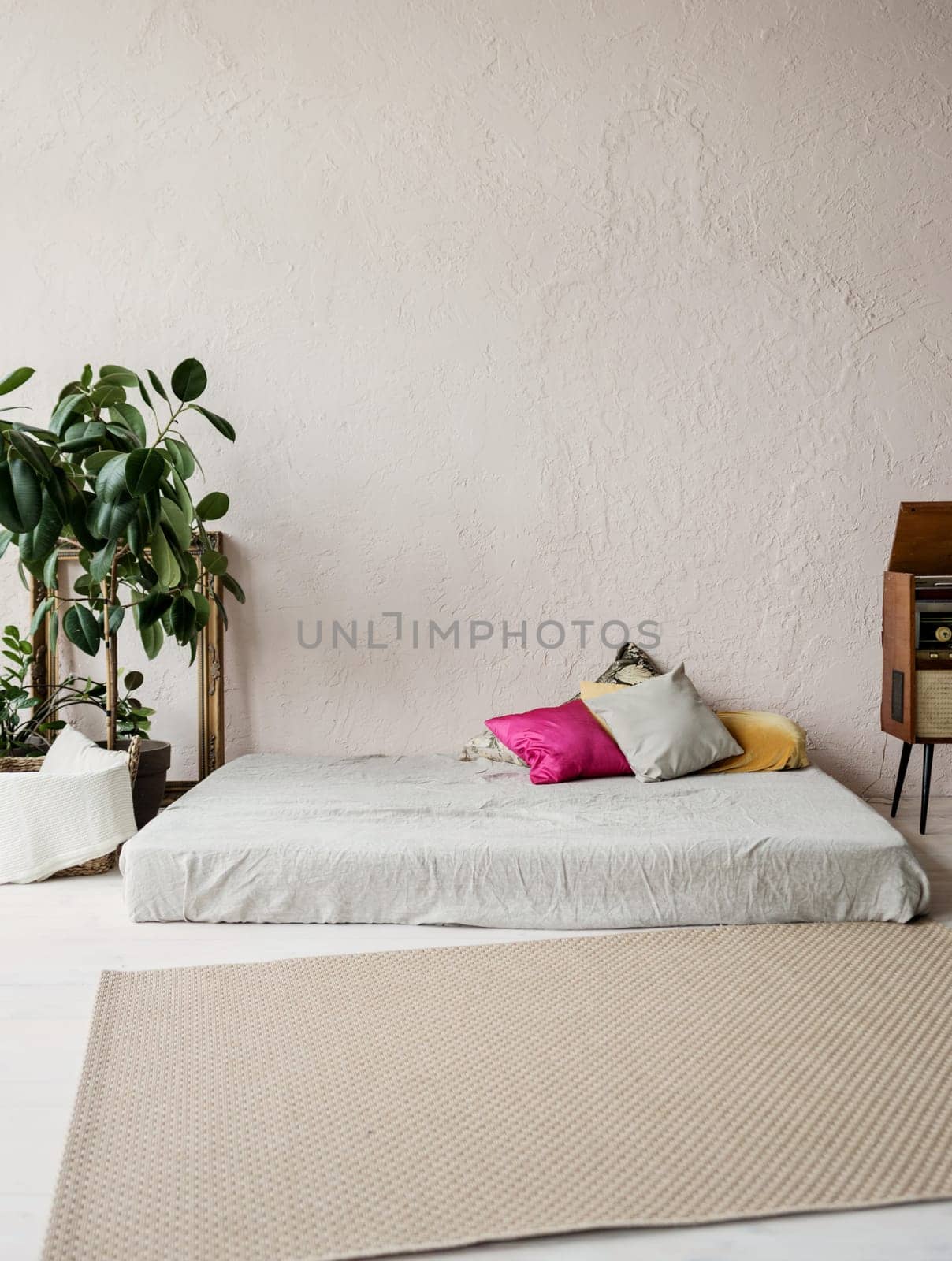 Beautiful loft bedroom with bed near rough wall 