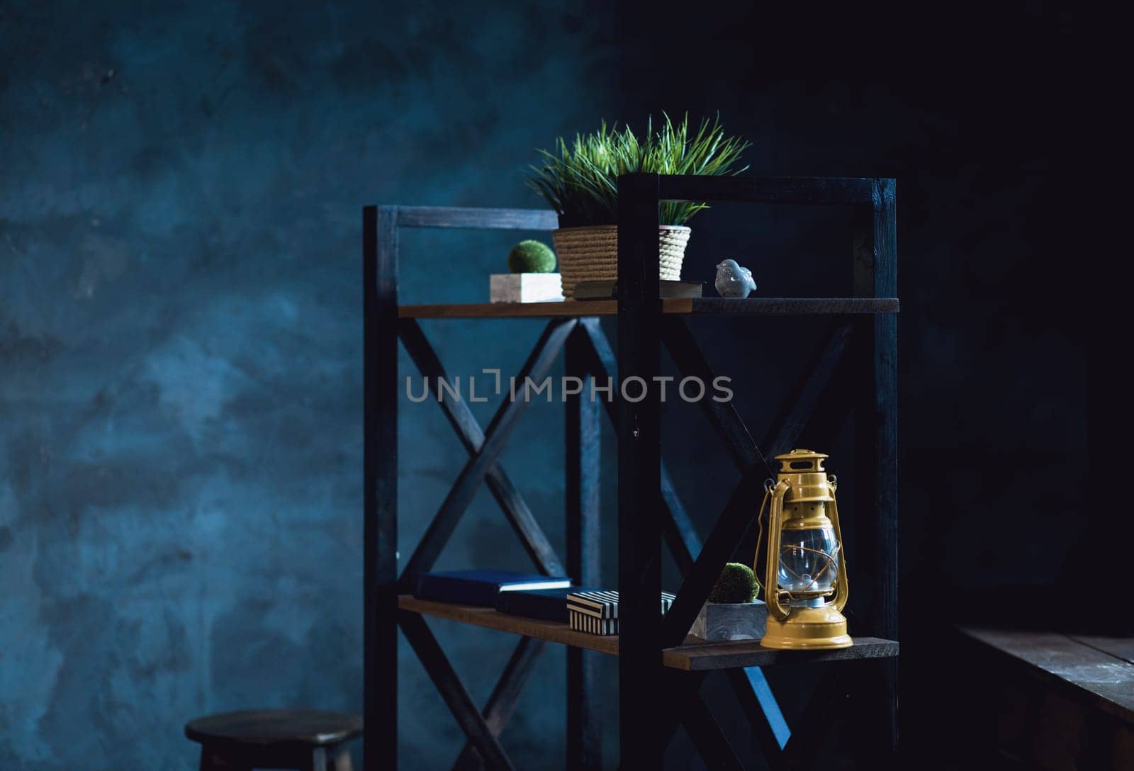contemporary loft interior with shelves full of decor objects on the blue wall