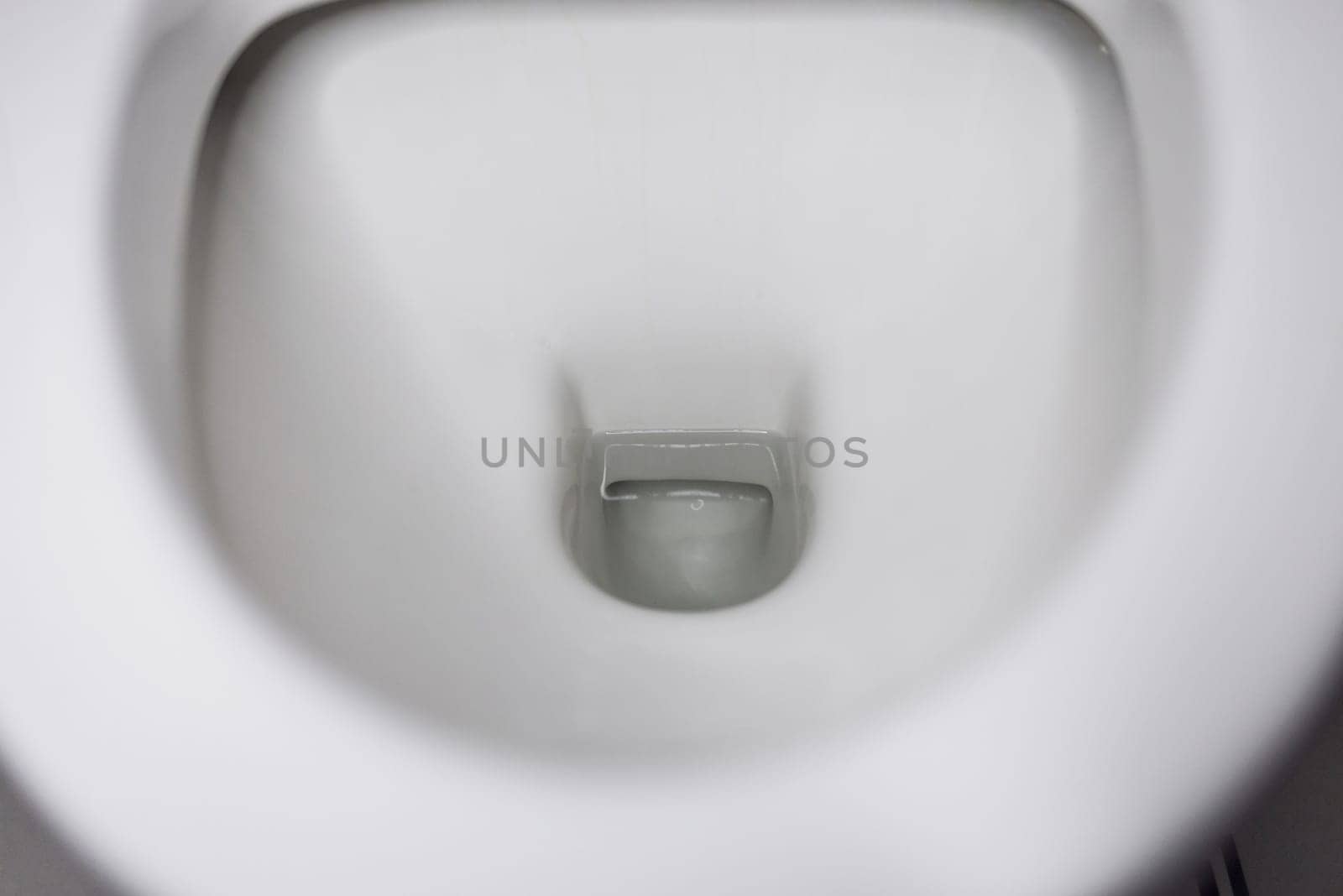 porcelain toilet bowl with water.