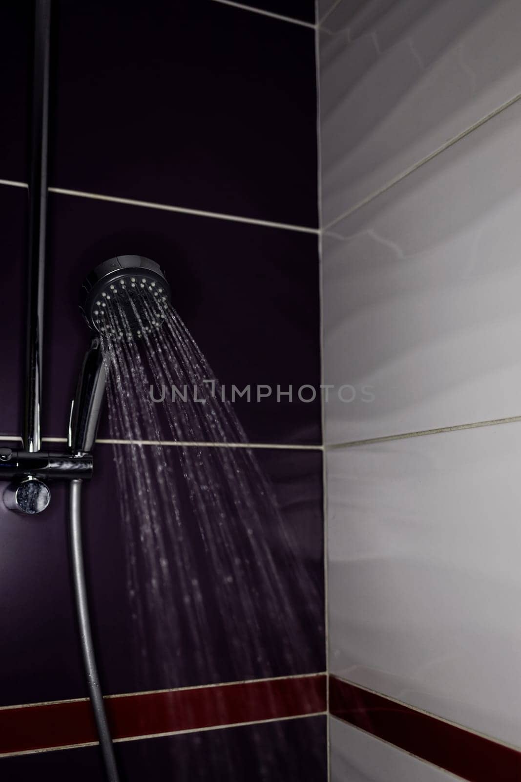 Fresh shower behind wet with water drops splashing. Water running from shower head.