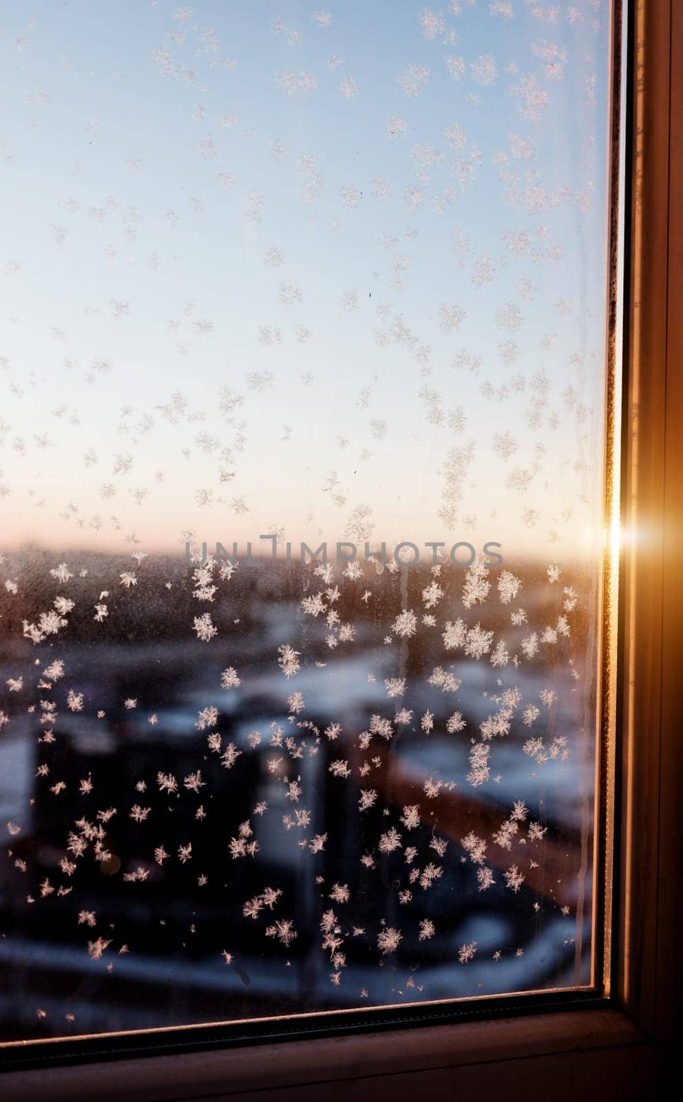 frost on the window and sunlight. sunrise