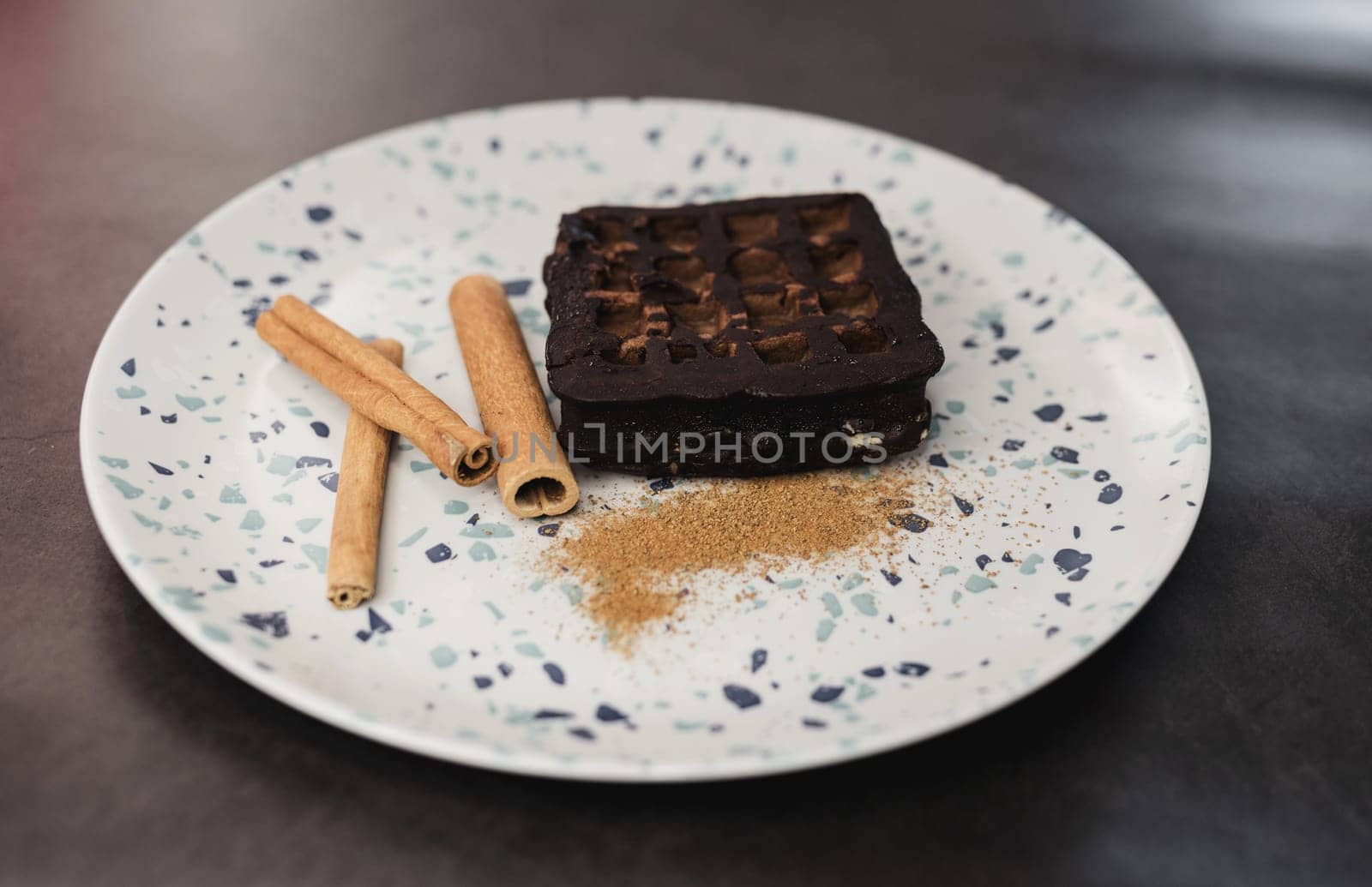 delicious chocolate cake with cinnamon sticks in a plate. sweet dessert