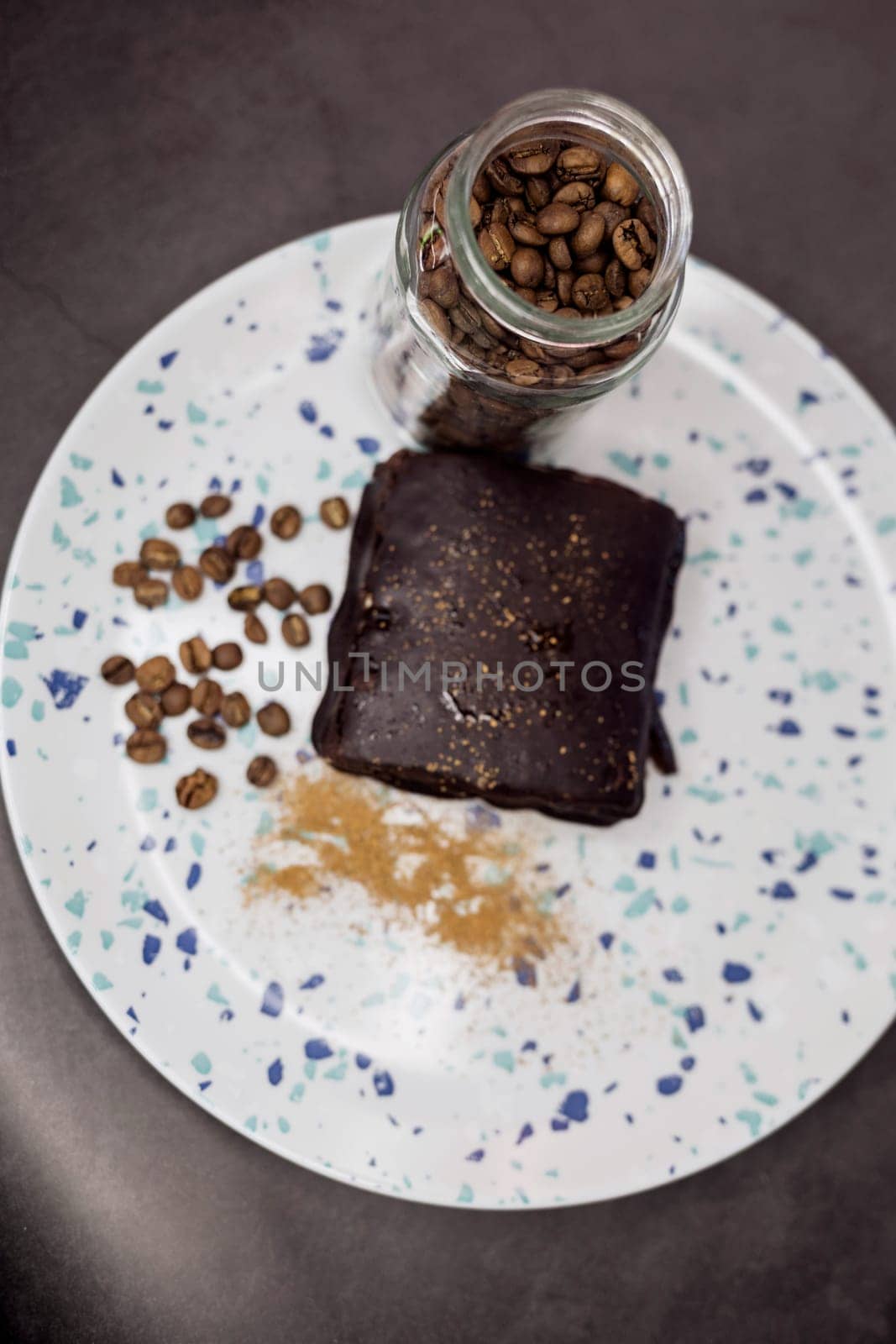 coffee beans and a sweet cake on a plate. selective focus