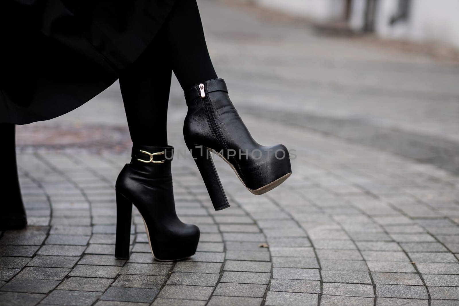 Elegant women black high heeled boots.  Concept of fashion and design, shopping