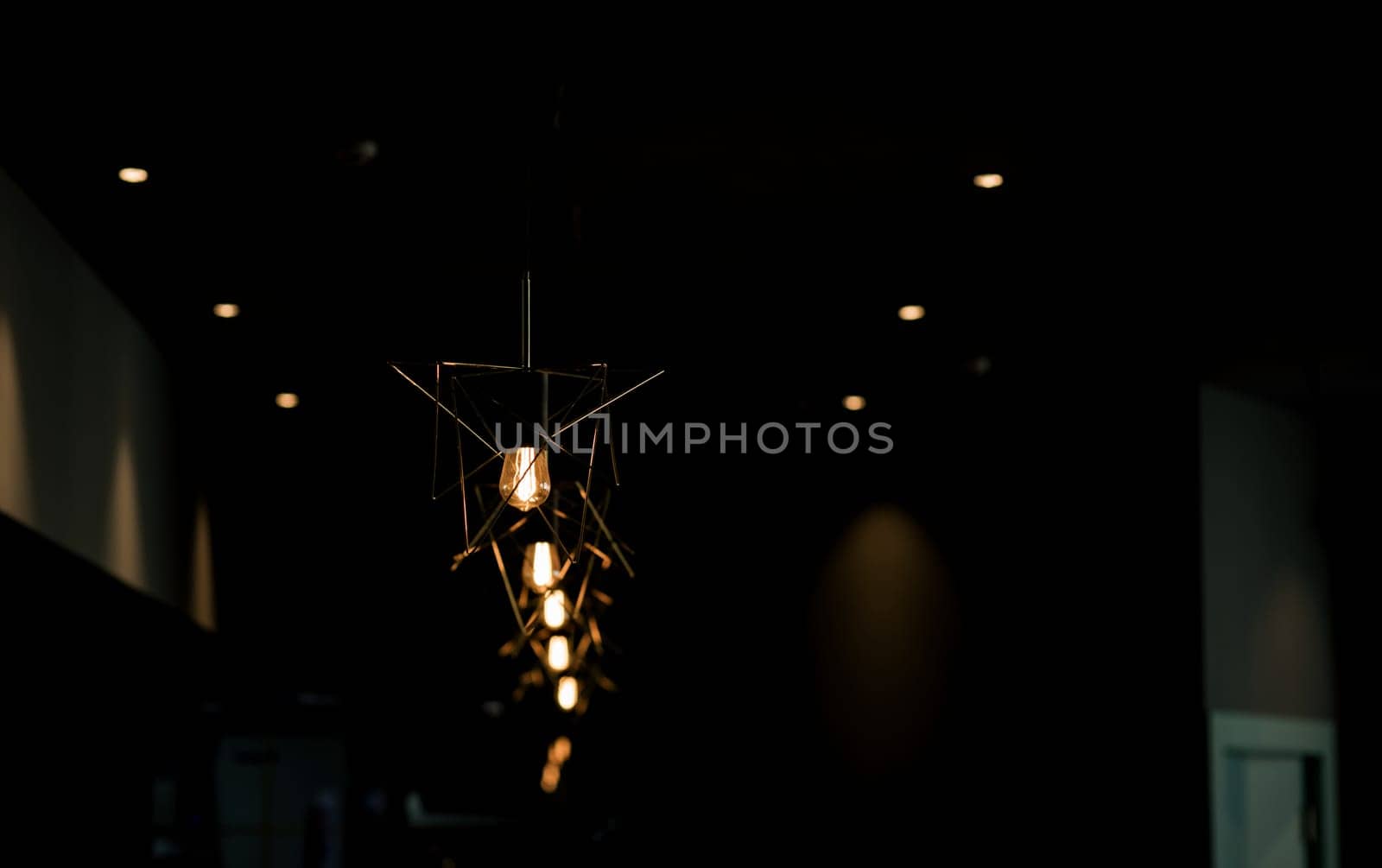 Minimalistic lamps decorated cafe in a modern loft style. Yellow color light.