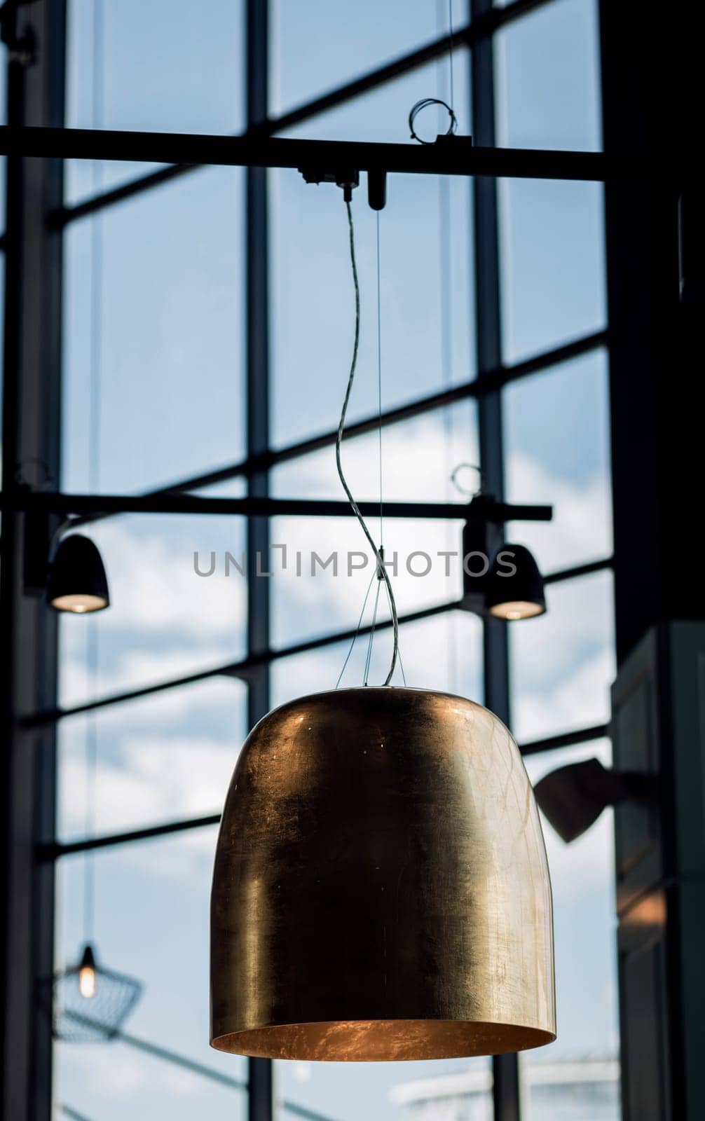 Old brass chandelier in cafe. metallic lamp