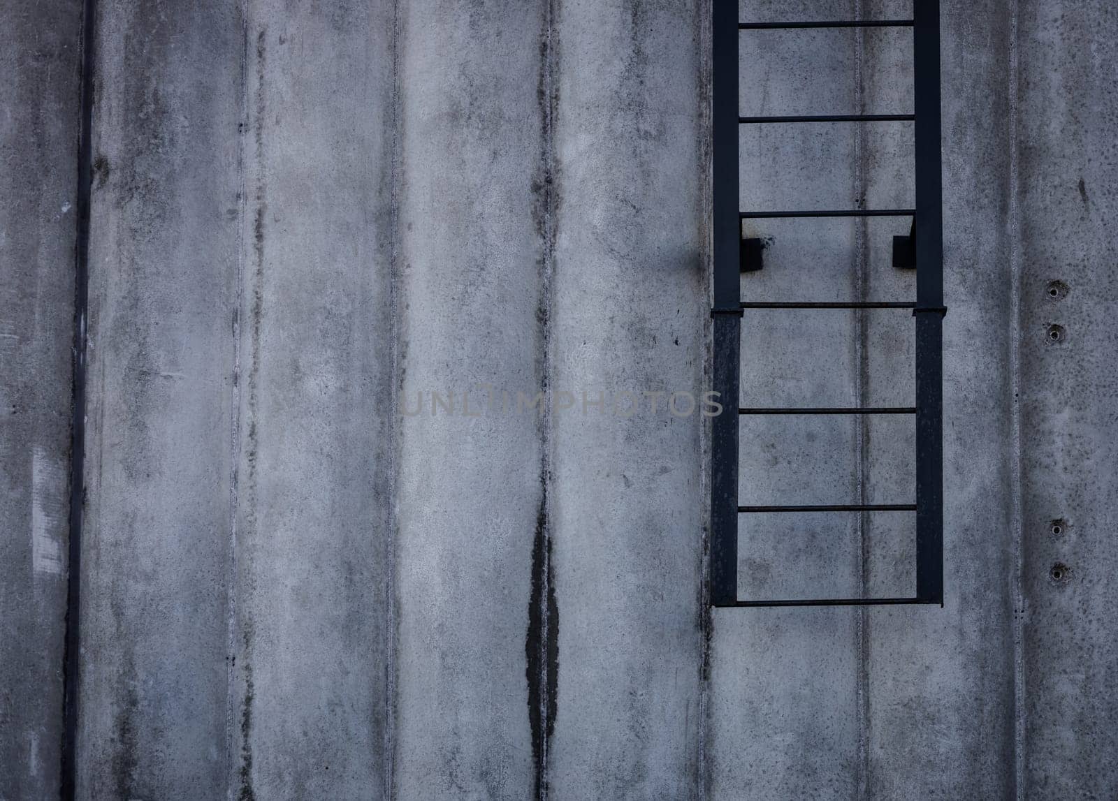 concrete wall with ladder. space for text. rough texture