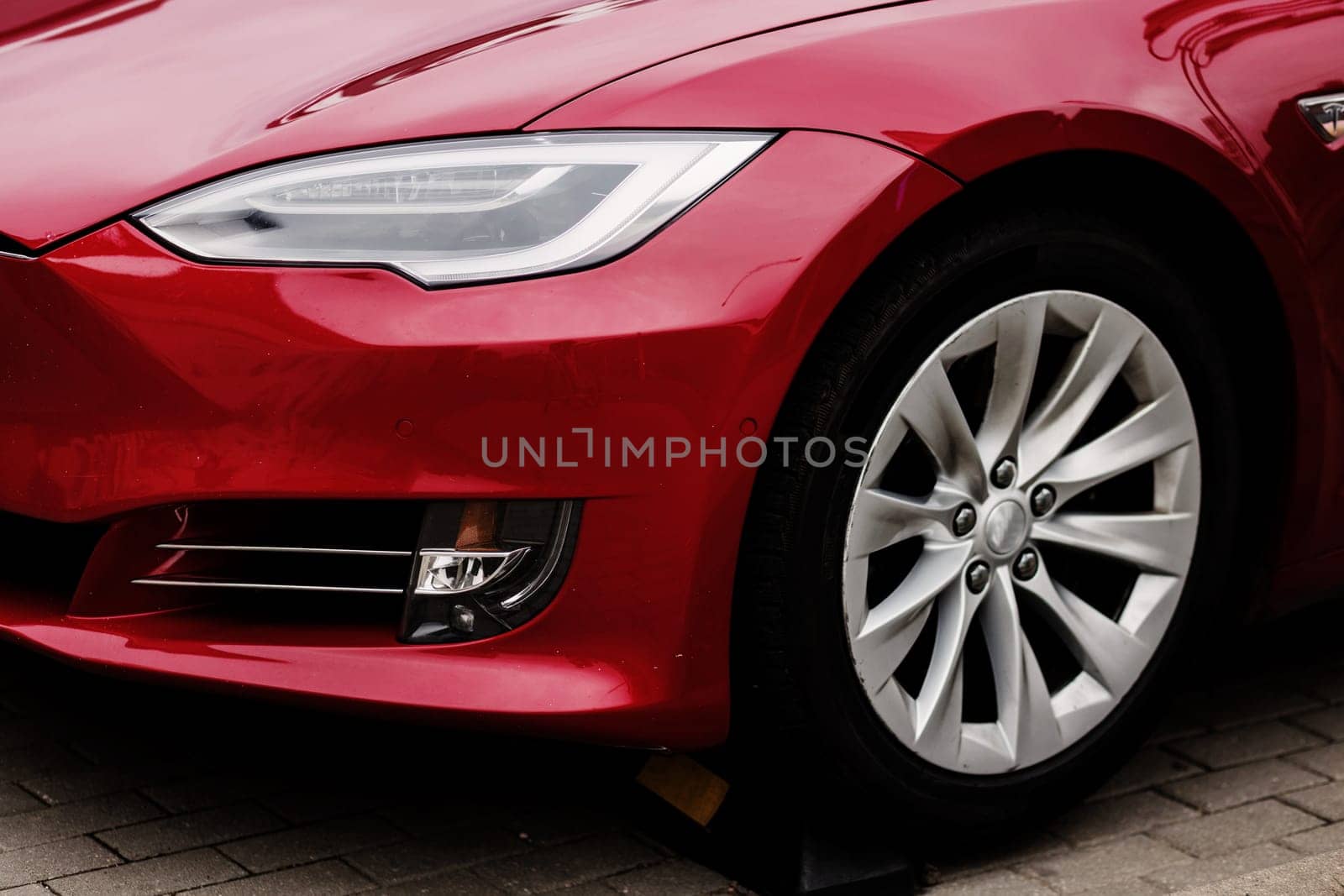Headlights and hood of sport red car on parking