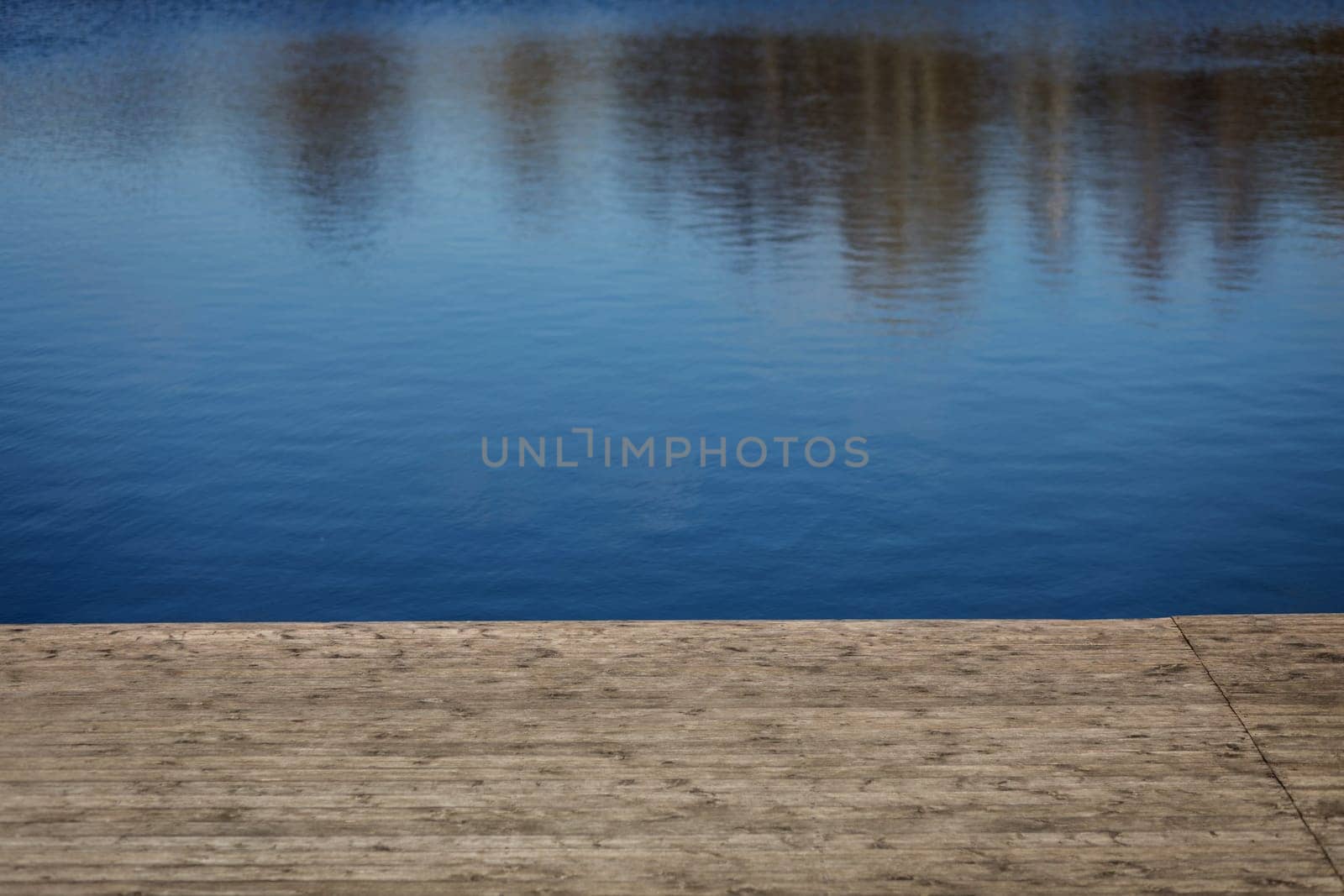 Wooden pier with blue sea and water background